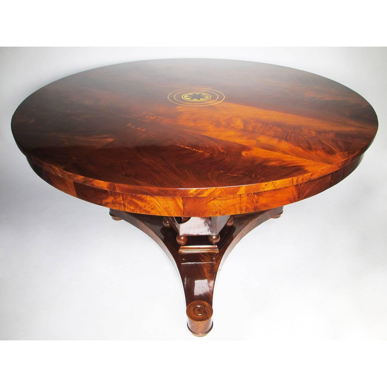 A very fine and rare Biedermeier style 19th century mahogany marquetry center hall table, the circular top with conforming frieze above a tulip shaped shaft, raised on spheres above a tripart base ending on compressed bun feet, Vienna, circa