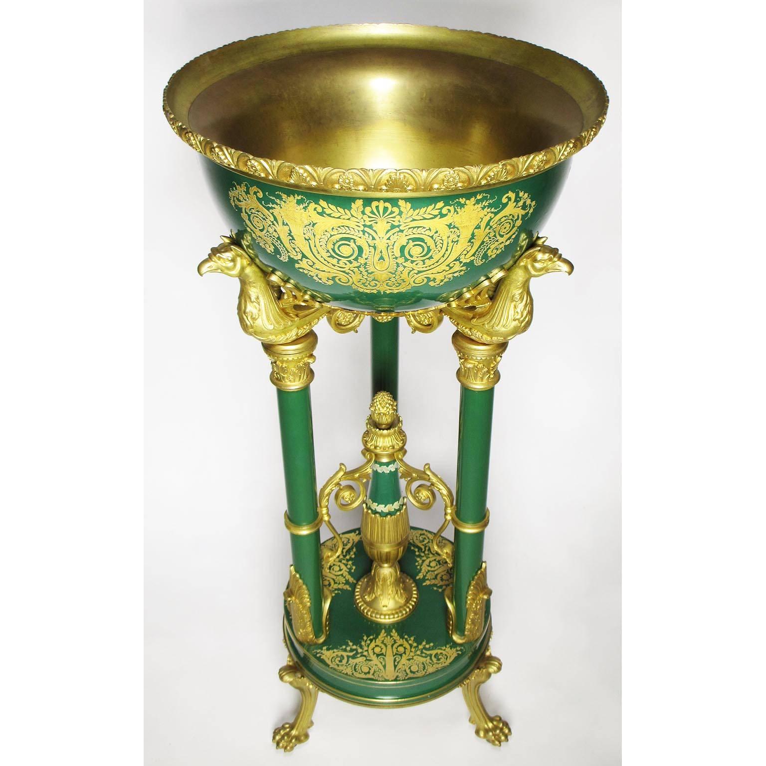 A very fine and rare French 19th century Napoleon III gilt bronze-mounted porcelain and enamel standing jardinière (planter) in the Egyptian Revival Style, probably by Sèvres, the circular green porcelain basin with relief gold decorations and