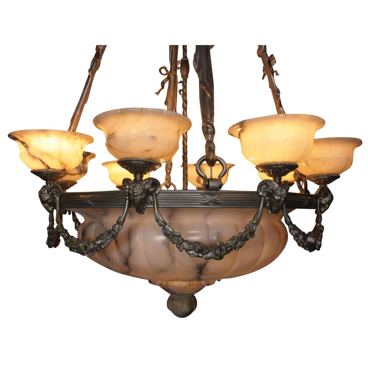 A large and rare early French 20th century Art Deco and silvered bronze carved veined cream alabaster eight-light figural chandelier. The impressive carved ovoid plafonnier with a carved finial mounted on a circular banded frame surmounted with
