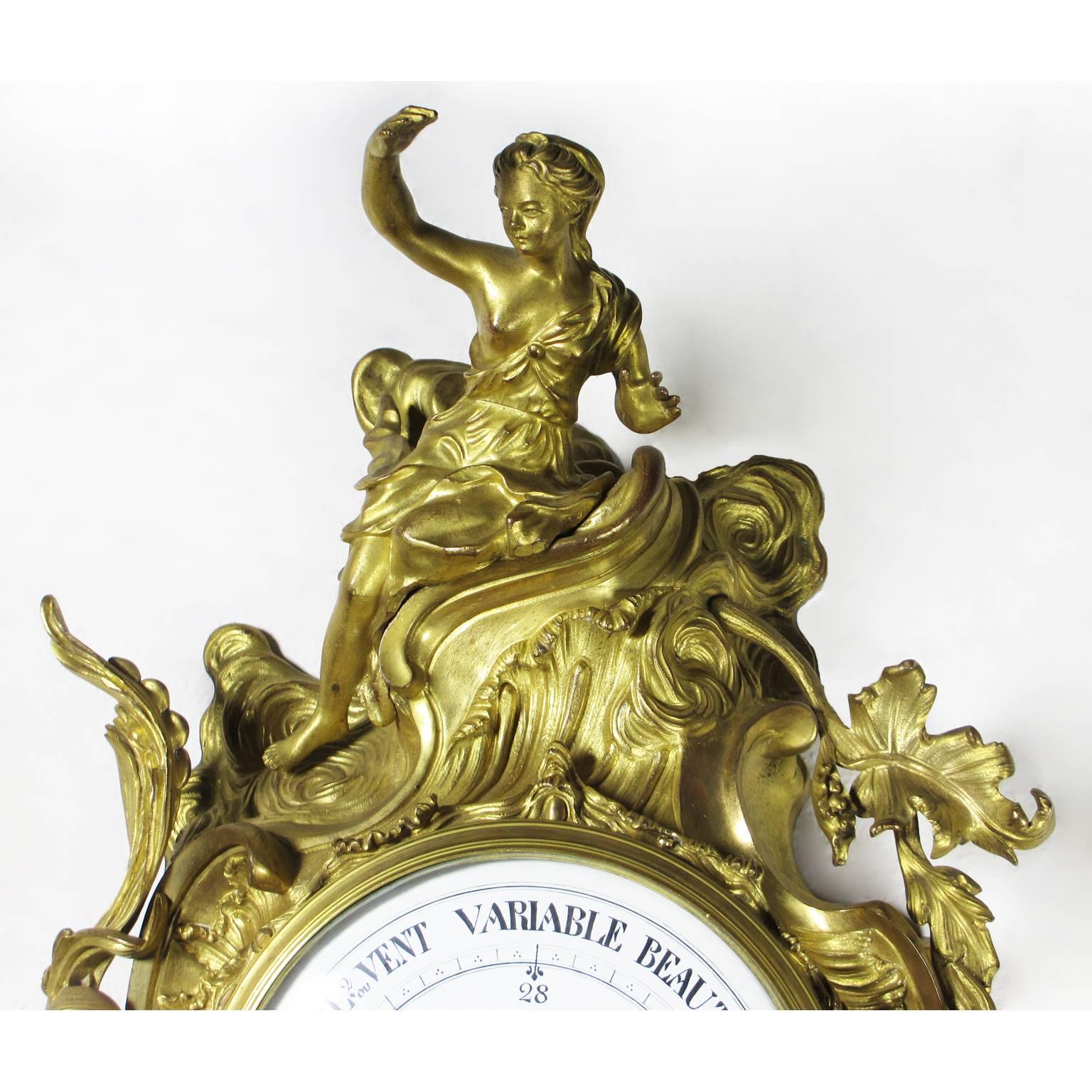 A very fine French 19th century Louis XV style gilt-bronze figural Cartel Barometer by A. Crin, A Paris. The wall mounting cartel barometer crowned with a figure of a seated maiden amongst acanthus and leaves, the circular porcelain dial with a