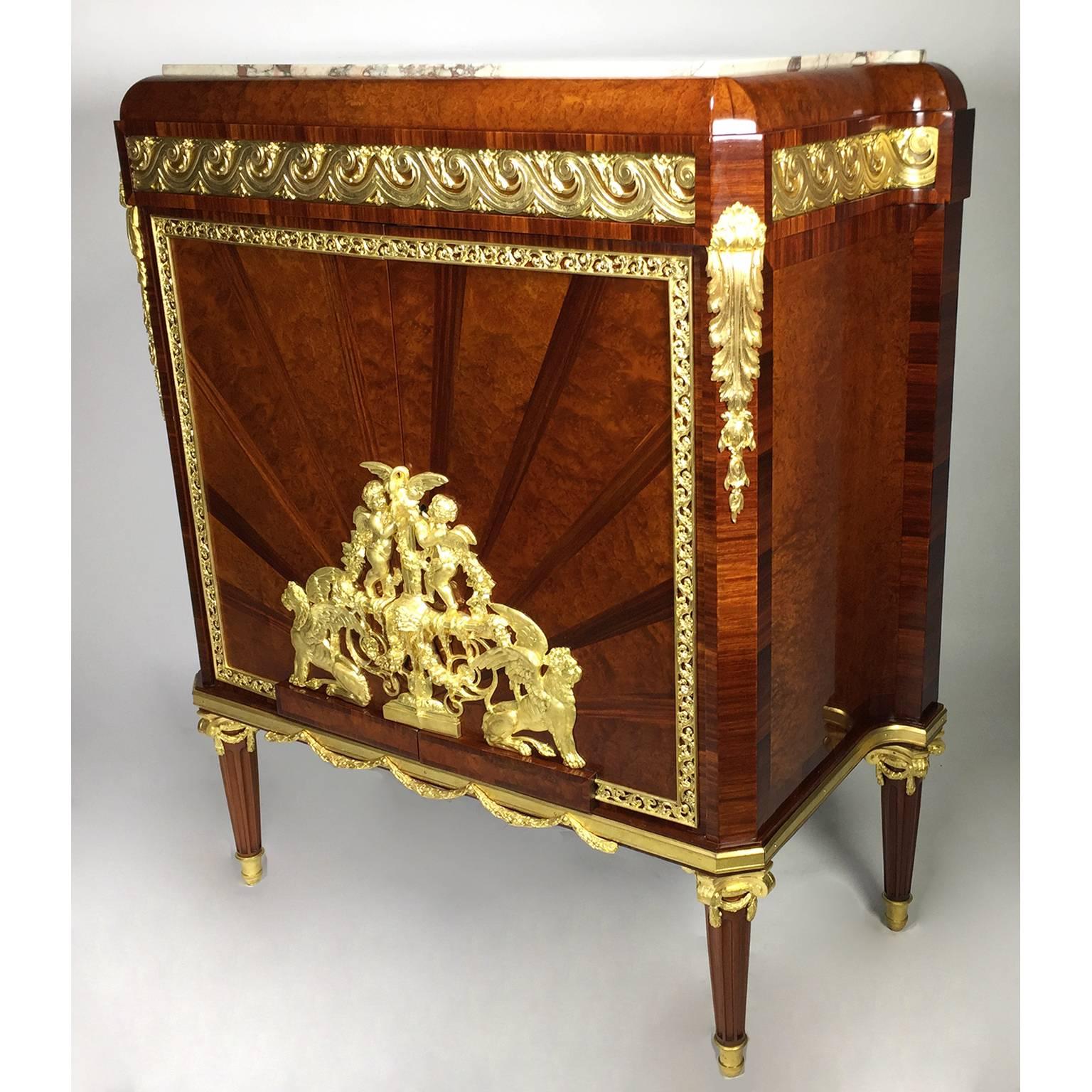A very fine and rare French 19th-20th century Louis XVI style Belle Epoque ormolu-mounted satine, kingwood and burlwood two-door cabinet, the mounts by Ferdinand Barbedienne, fitted with a shaped Breccia Colorata marble top above a Vitruvian scroll