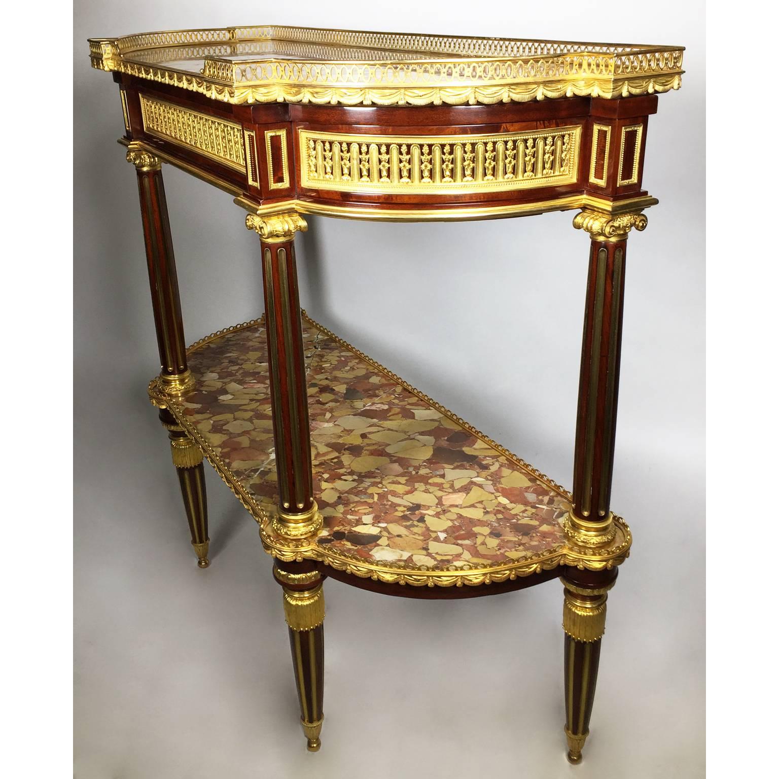A fine French 19th century Louis XVI style gilt bronze-mounted mahogany two-tier demilune console Desserte in the manner of Jean Baptiste Vassou, maître in 1767 and Jacques-Antoine Leclere, maître in 1780. The demilune galleried Brêche d'Alep