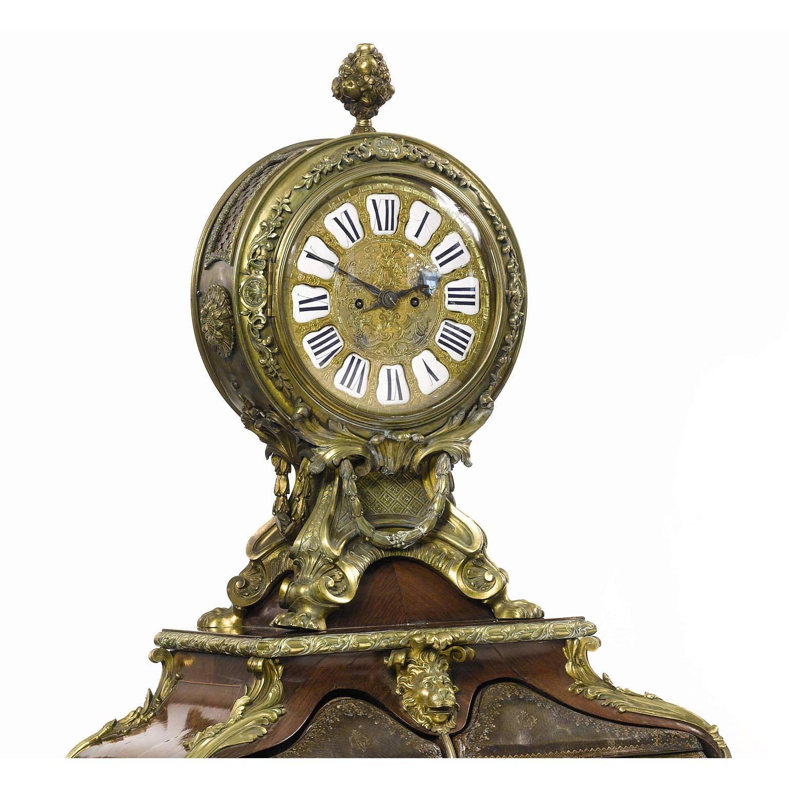 A very fine and palatial French 19th century Louis XV style gilt bronze mounted, leather, tulipwood and kingwood parquetry cartonnier with clock. The circular clock with elaborate pierced case with reticulated panels backed with silk lining, floral
