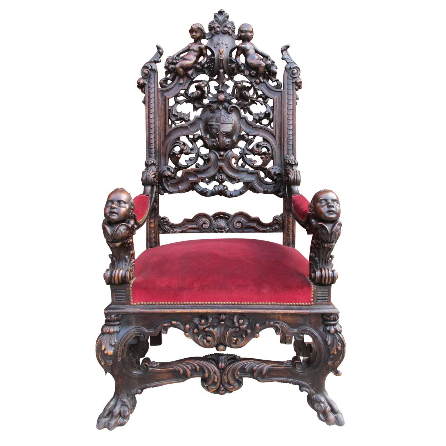 A fine and palatial pair of Italian 19th century renaissance style carved walnut figural throne armchairs. The intricately carved Baroque frames with the backrests depicting a pair of resting Putti above foliage, scrolls and acanthus, centred with a