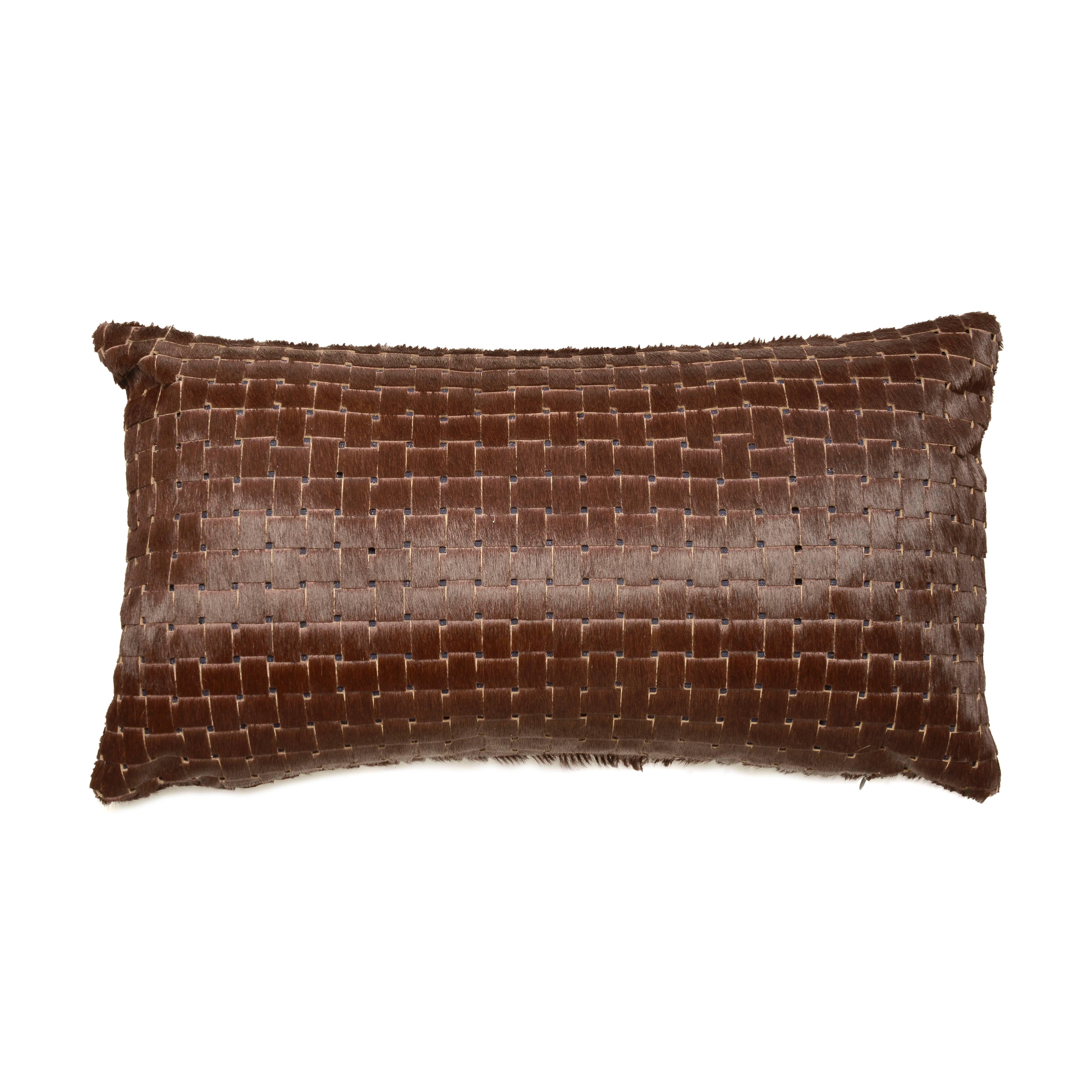 Chocolate brown laser cut cowhide hair lumbar pillows. 

Luxurious high sheen cowhide from Normandy, France.
Chocolate brown with navy lining visible through sure laser cuts.
Basket weave laser cut pattern.
12