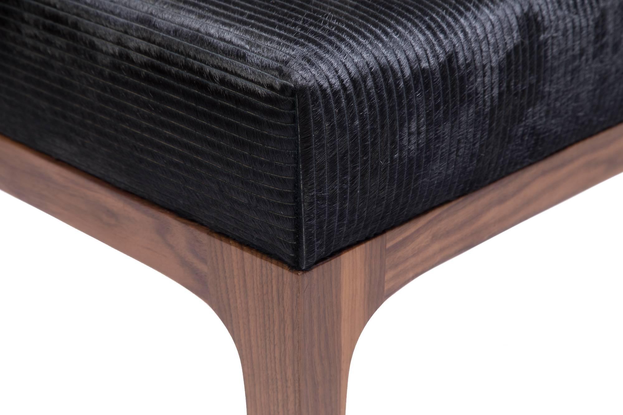 The Raphael walnut Ottomans by KLASP home.
Pair of Mid-Century Modern style with a laser cut pattern black cowhide upholstered ottomans, sold as a pair.
Laser cut stripe pattern cowhide in black.
Sold as a pair.
Normandy cowhide.
Mid-Century Modern