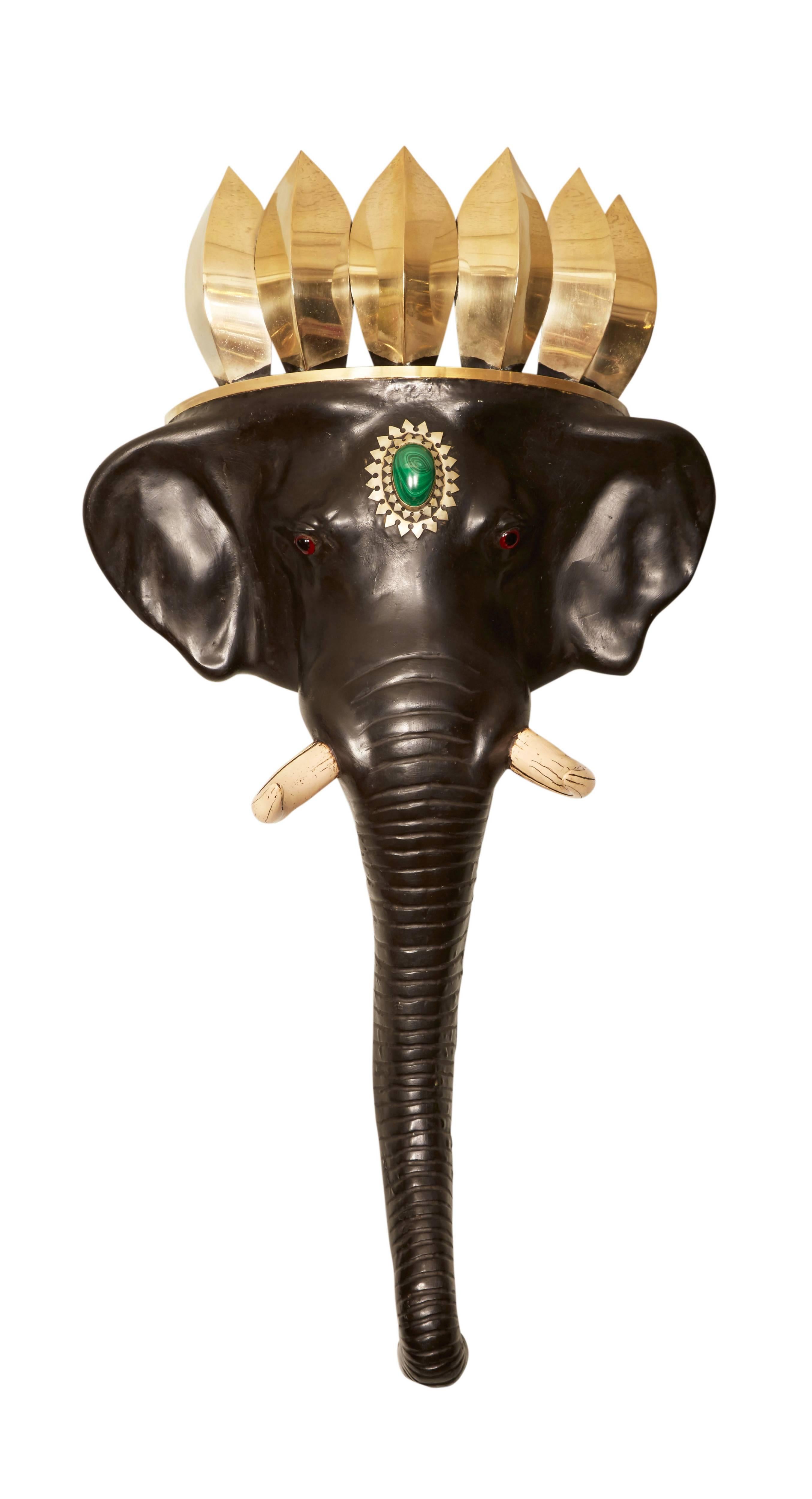 A very nice and fun pair of elephant head wall brackets, with polished steel, faux tusks and malachite amulets. 

After Anthony Redmile, London.

  