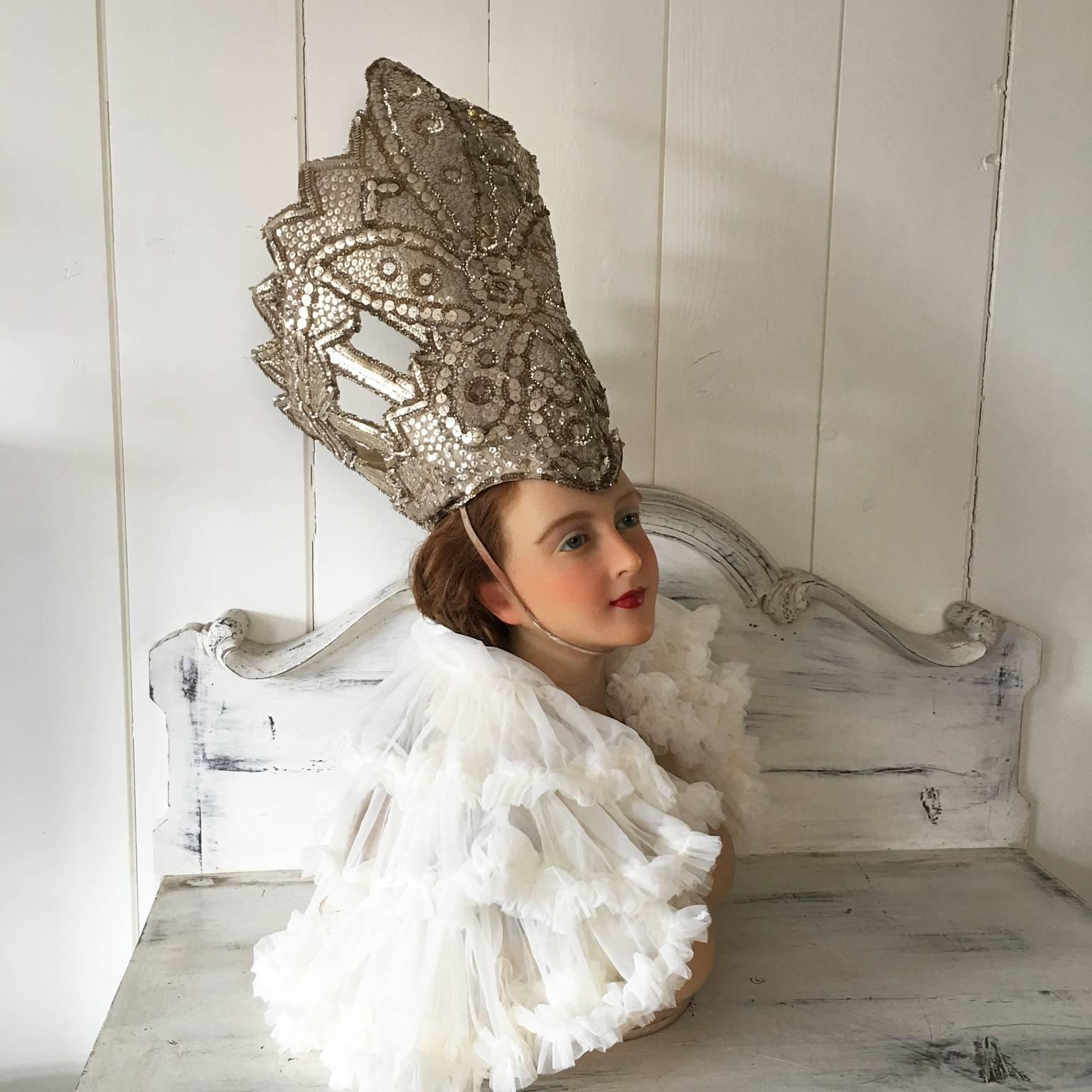 A beautiful vintage stage headdress from the 1950s, once used in a theatre's play or performance. The beautiful shaped headdress is fully handmade out of a re-inforced fabric and hundreds of different sized gold colored sequins embroidered by hand