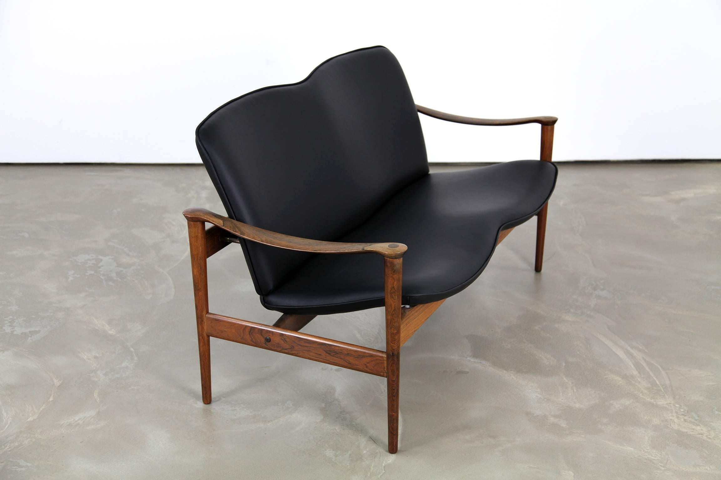 Stunning and extremely rare two-seat sofa, designed by Frederik A. Kayser, produced by Vatne in the early 1960s. The frame is made of rosewood, seat and back are upholstered with black leather.
 