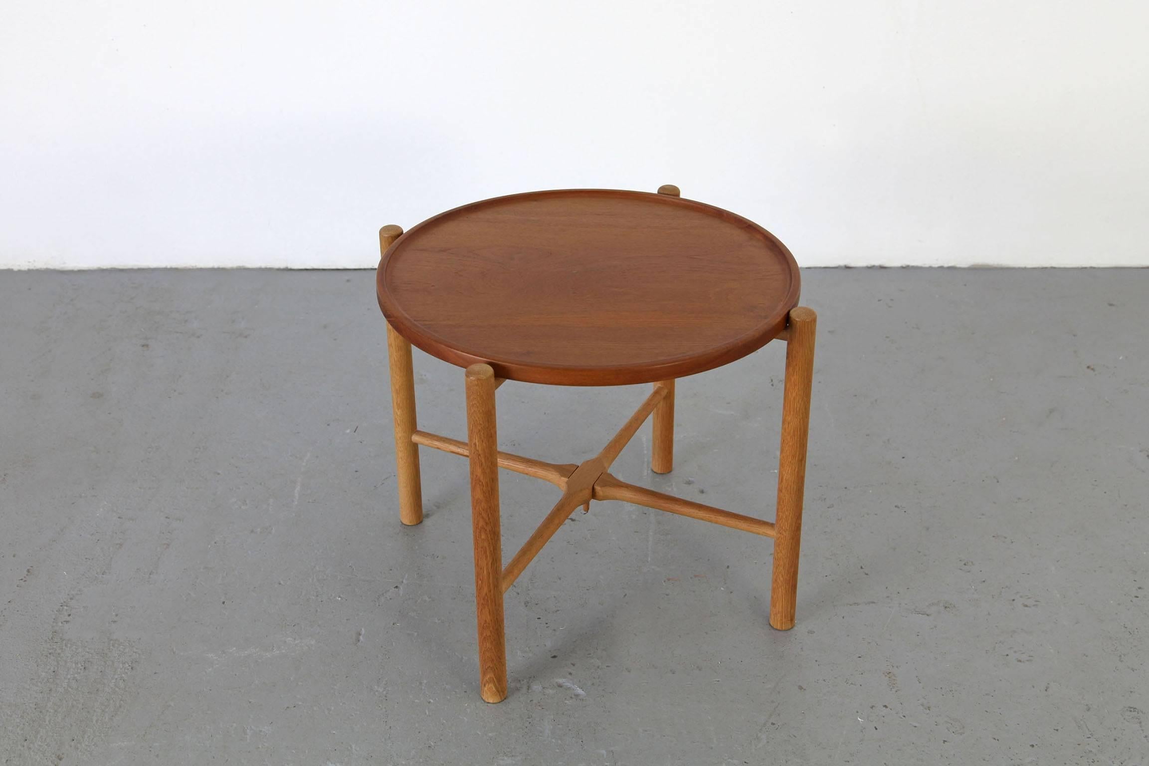 Filigree folding table mod. AT-35, designed by Hans J. Wegner for Andreas Tuck. Oak folding frame with reversible teak top. Beautiful, elegant shape. Labelled on frame. The table is in excellent condition.