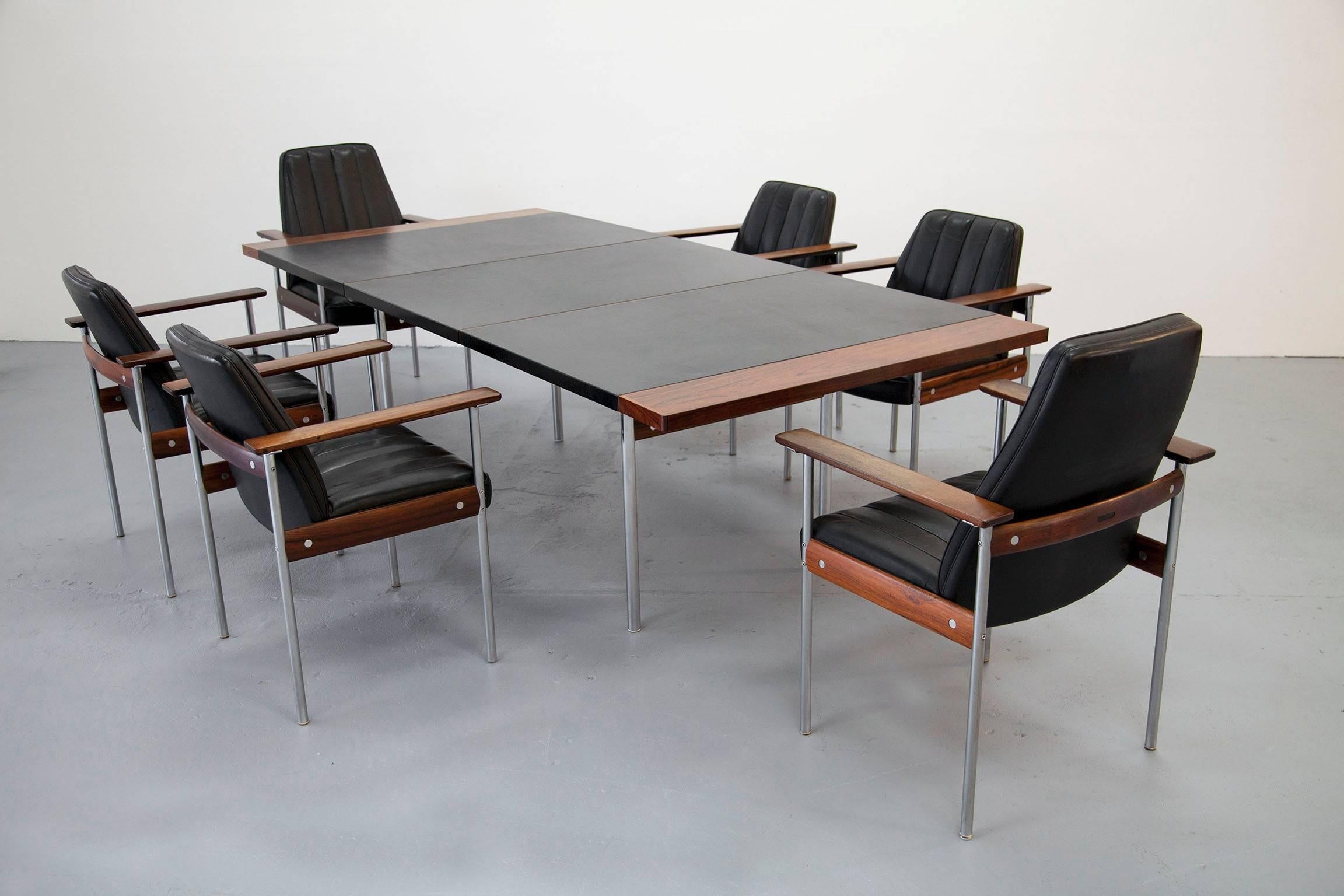 Great set designed by Sven Dysthe consisting of six rosewood arm chairs (two highback chairs) and great table. This set is produced by Dokka, Norway. 

Dimensions:
Table: 110x240x75 cm. 
Chairs: 56cmx64cmx84cm [WxDxH].
Higback Chairs: