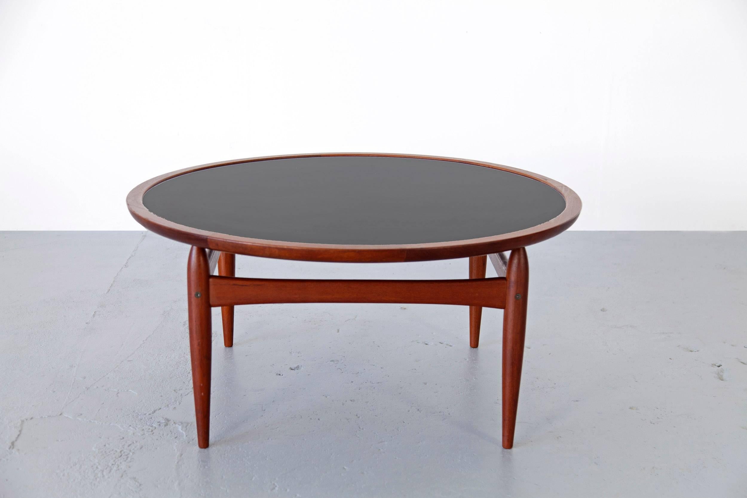 Very rare coffee table with reversible top, designed by Kurt Østervig and produced by Jason Møbler, Denmark. The table is made of teakwood and features a black formica top.
 