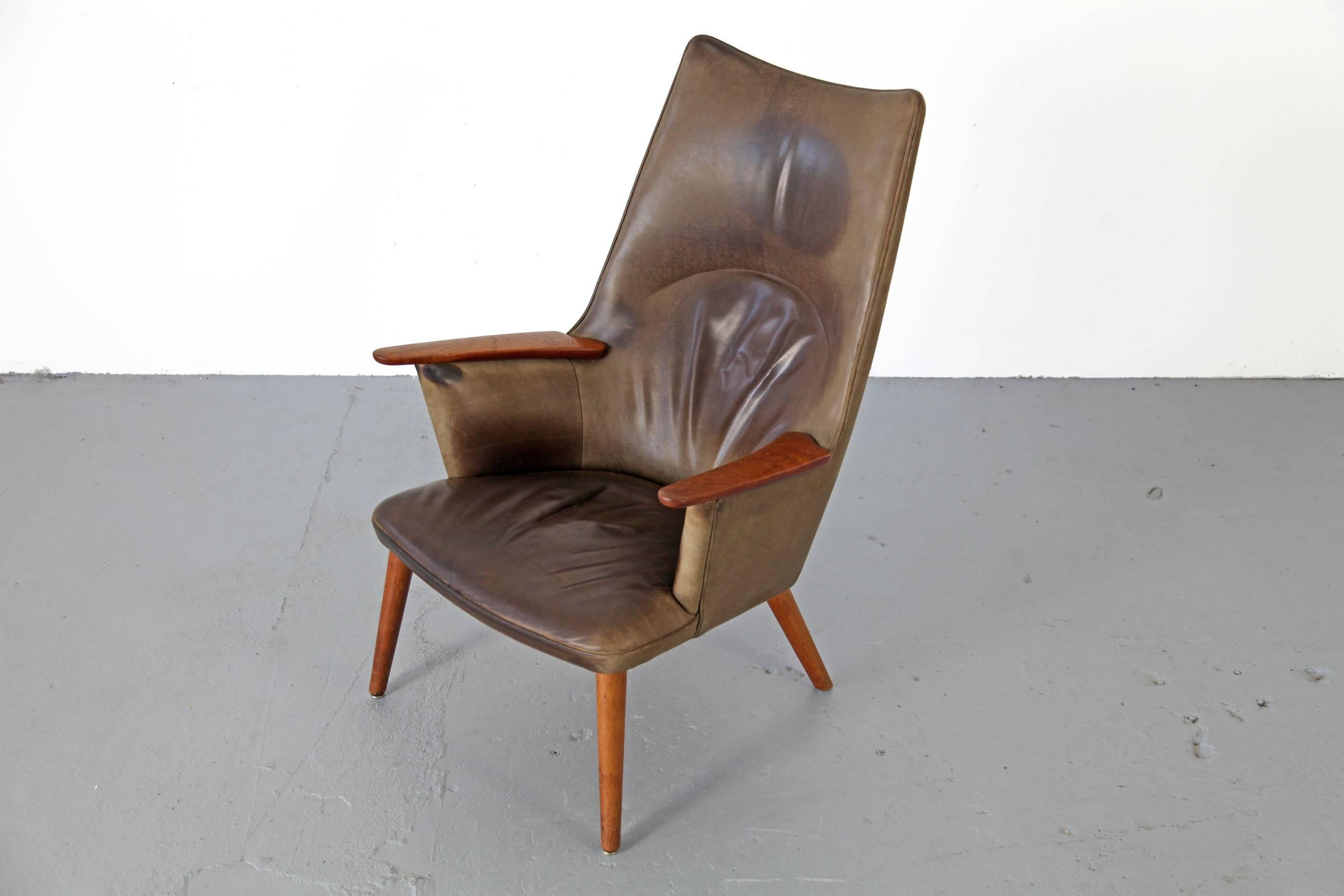 Lounge chair AP 27 by Hans Wegner, manufactured by A.P. Stolen. The chair has been upholstered in high quality leather, which has patinated nicely through decades.

