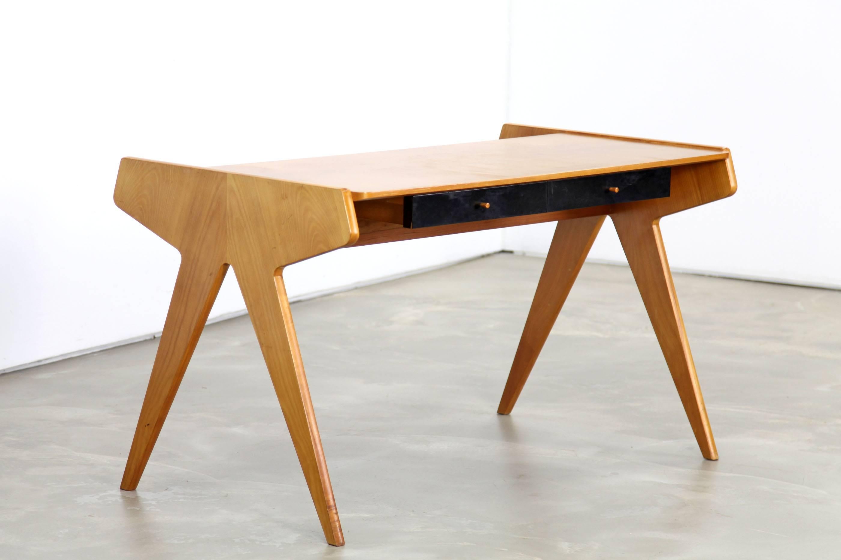 Beautiful cherrywood desk from the 1950s. Pure and simple design by Helmut Magg for WK, Germany. This desk combines functionality and elegance, it features two drawers a bookshelf and "scissor style" legs.