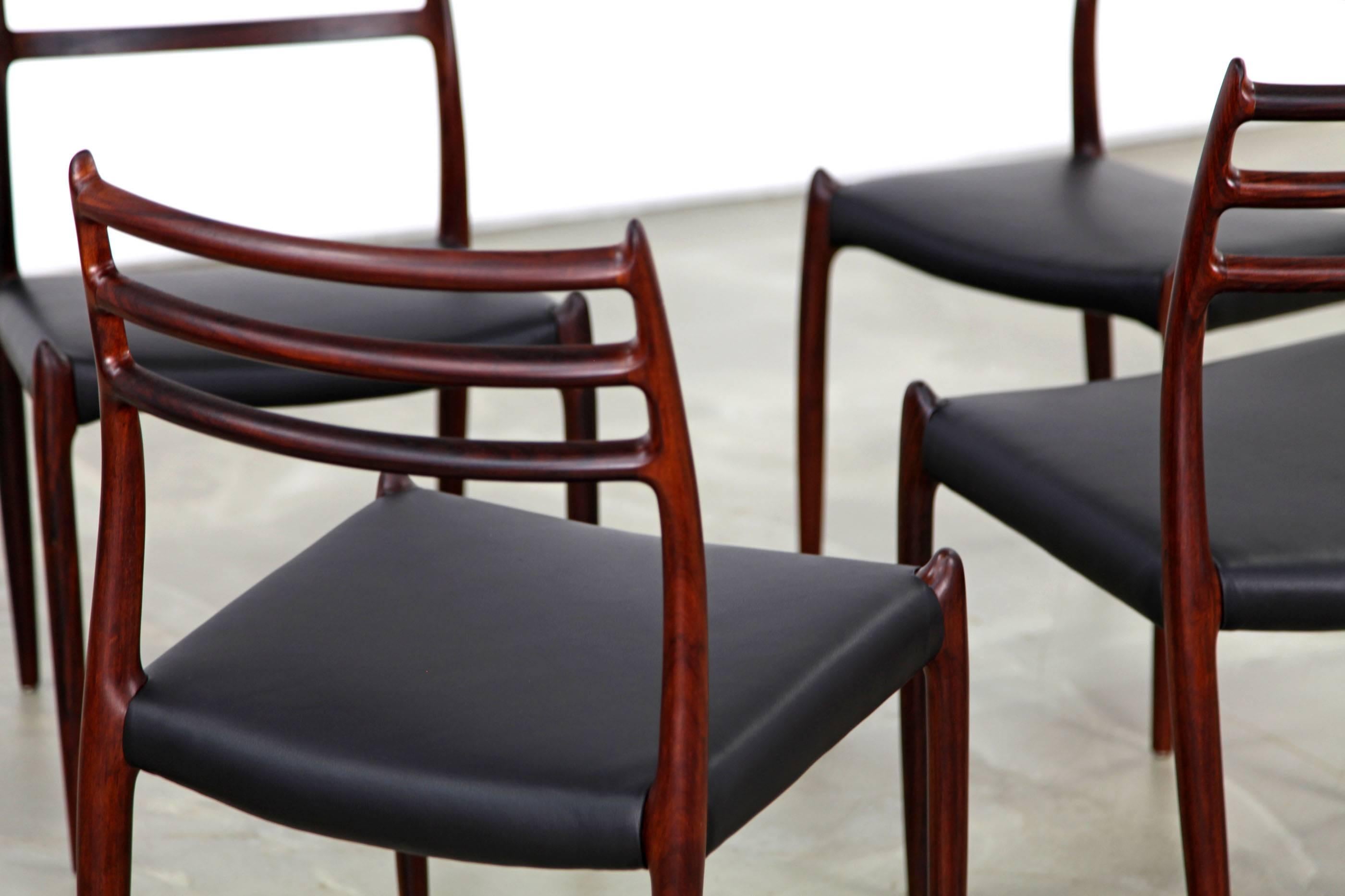 Set of four rosewood chairs from the 1960s, designed by Niels O. Møller. The chairs have been reupholstered with black aniline leather.