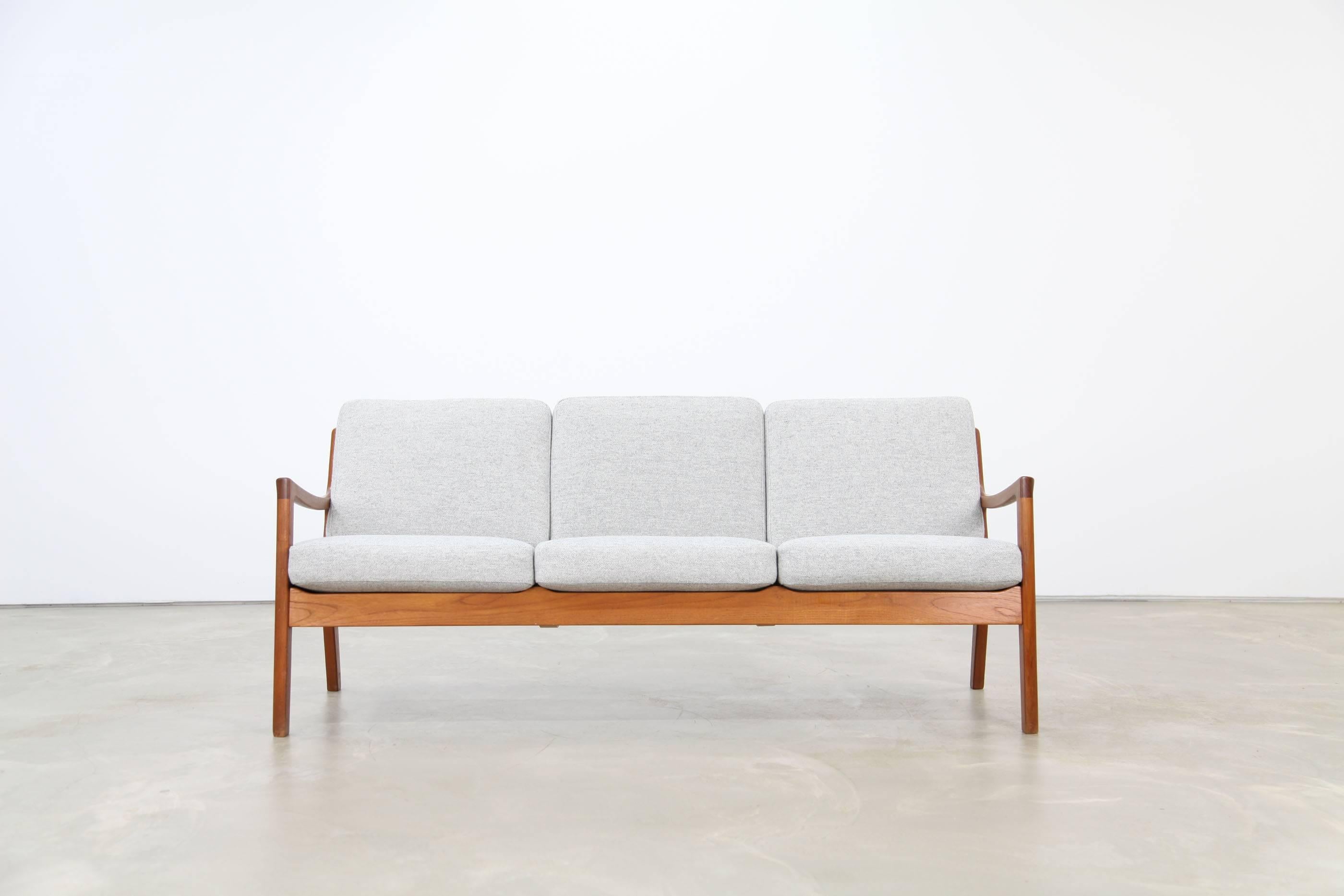 Three-seat sofa by the Danish designer Ole Wanscher for France & Søn. High quality and graceful teakwood frame. The cushions were re-upholstered with the fabric Hallingdal by Kvadrat. Great used condition.