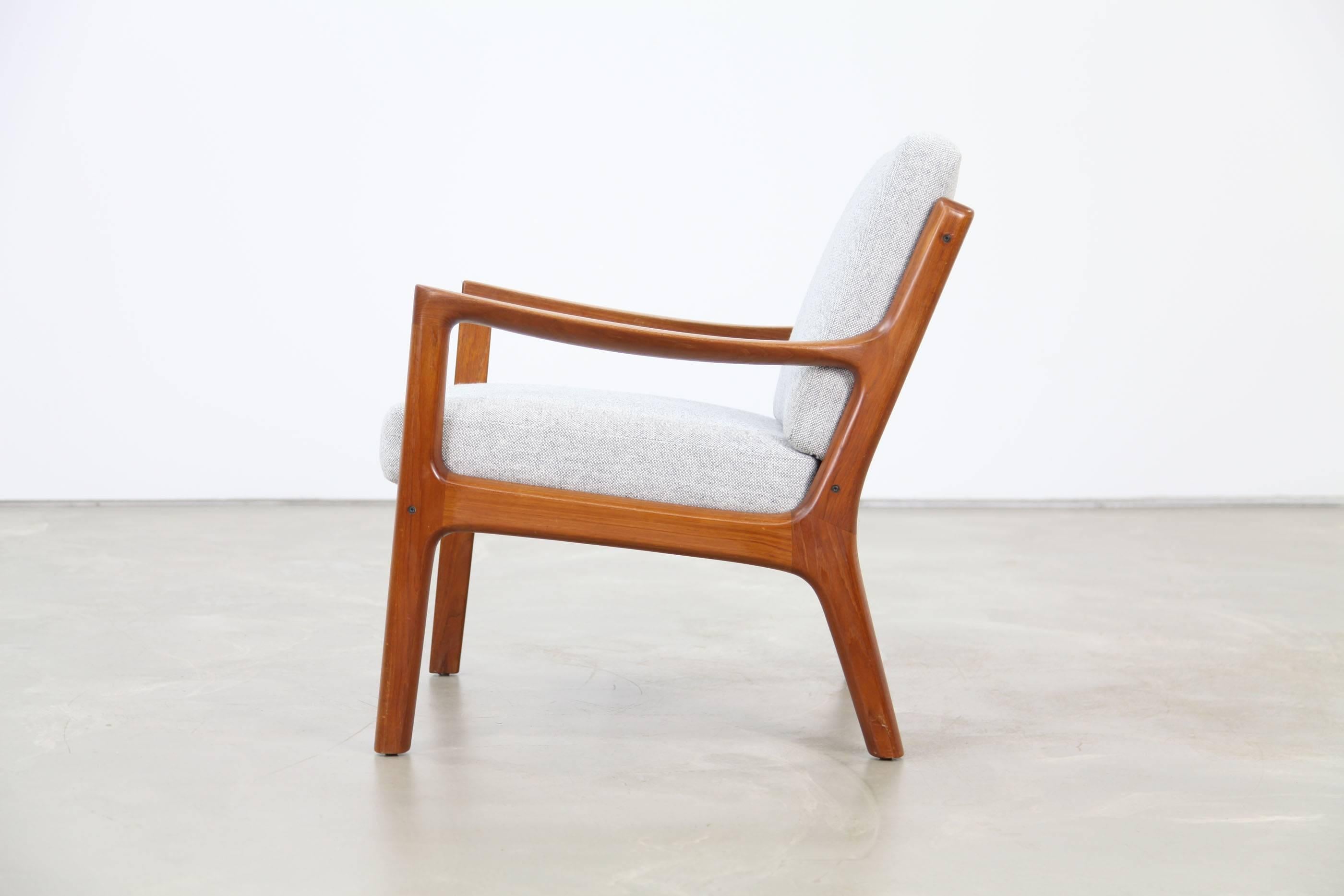 Easy chair by the Danish designer Ole Wanscher for France & Søn. High quality and graceful teakwood frame. The cushions were re-upholstered with the fabric Hallingdal by Kvadrat. Great used condition.