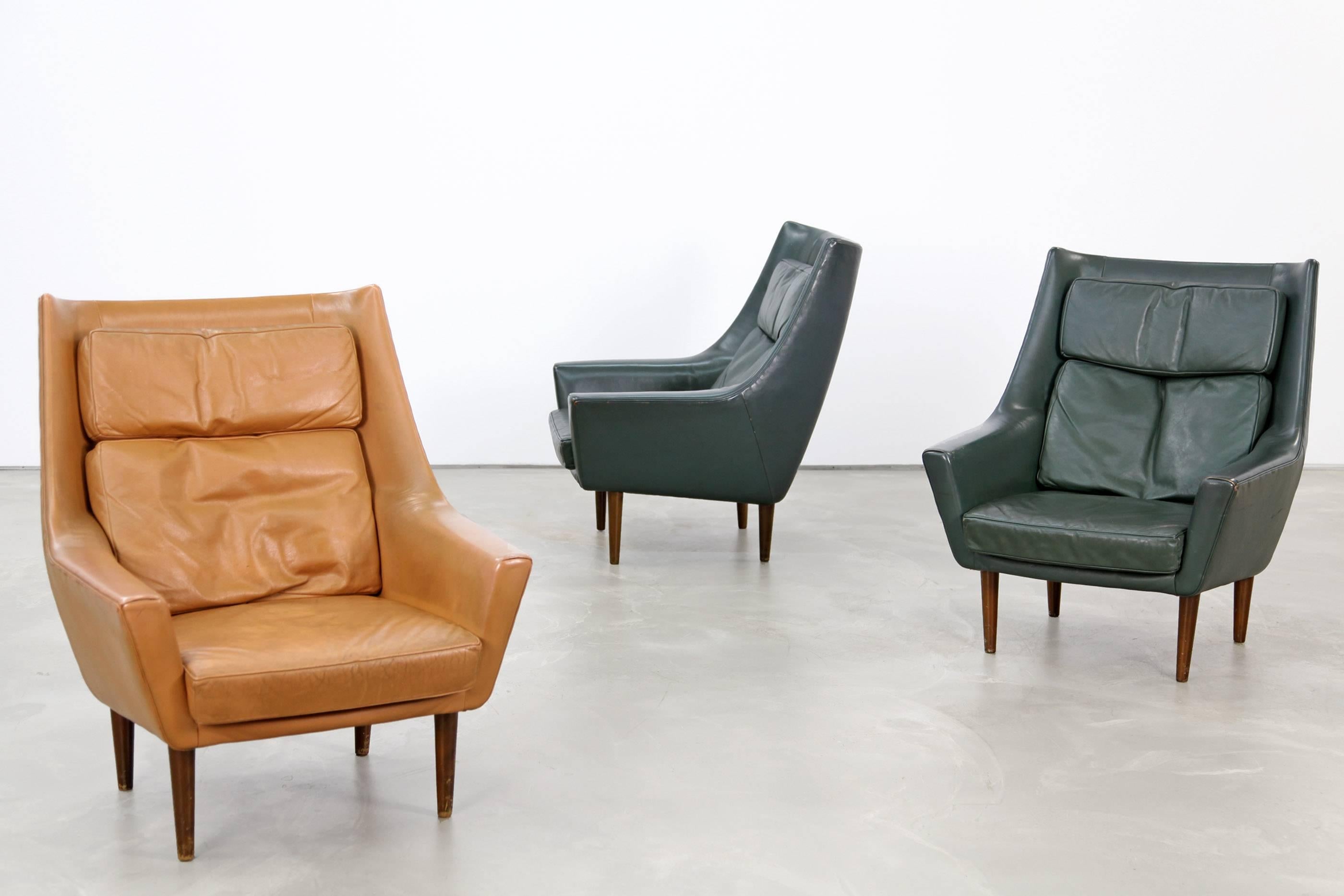 Beautiful set of two leather lounge chairs from the 1960s. These chairs were produced in Denmark, the design is attributed to Hans Olsen. The chairs are upholstered in dark green original leather and are in beautifully patinated condition.