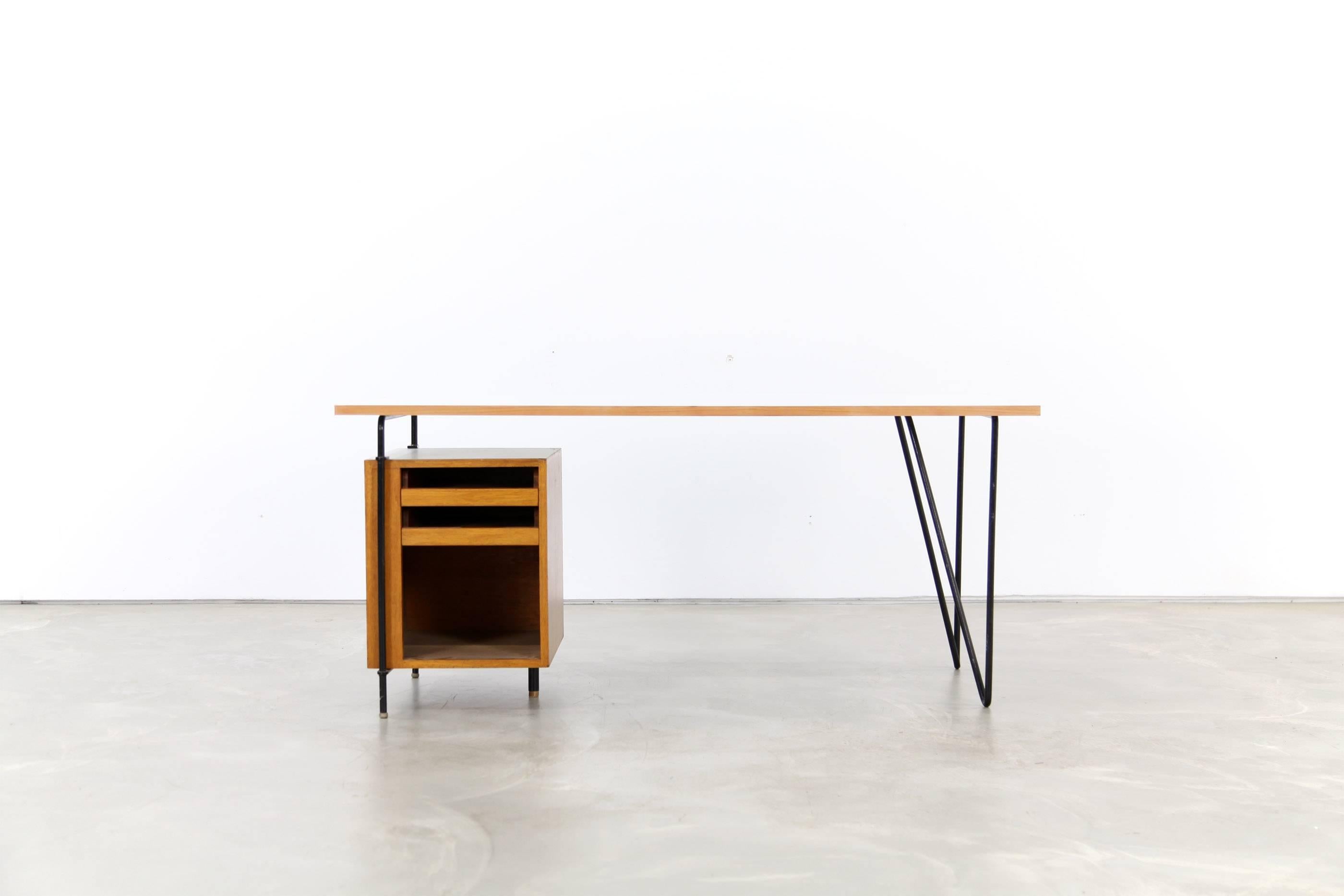 Architect's desk by a German architect for her own studio. Veneered wood with Formica tops. The table's design allows placing the drawer box in different positions.