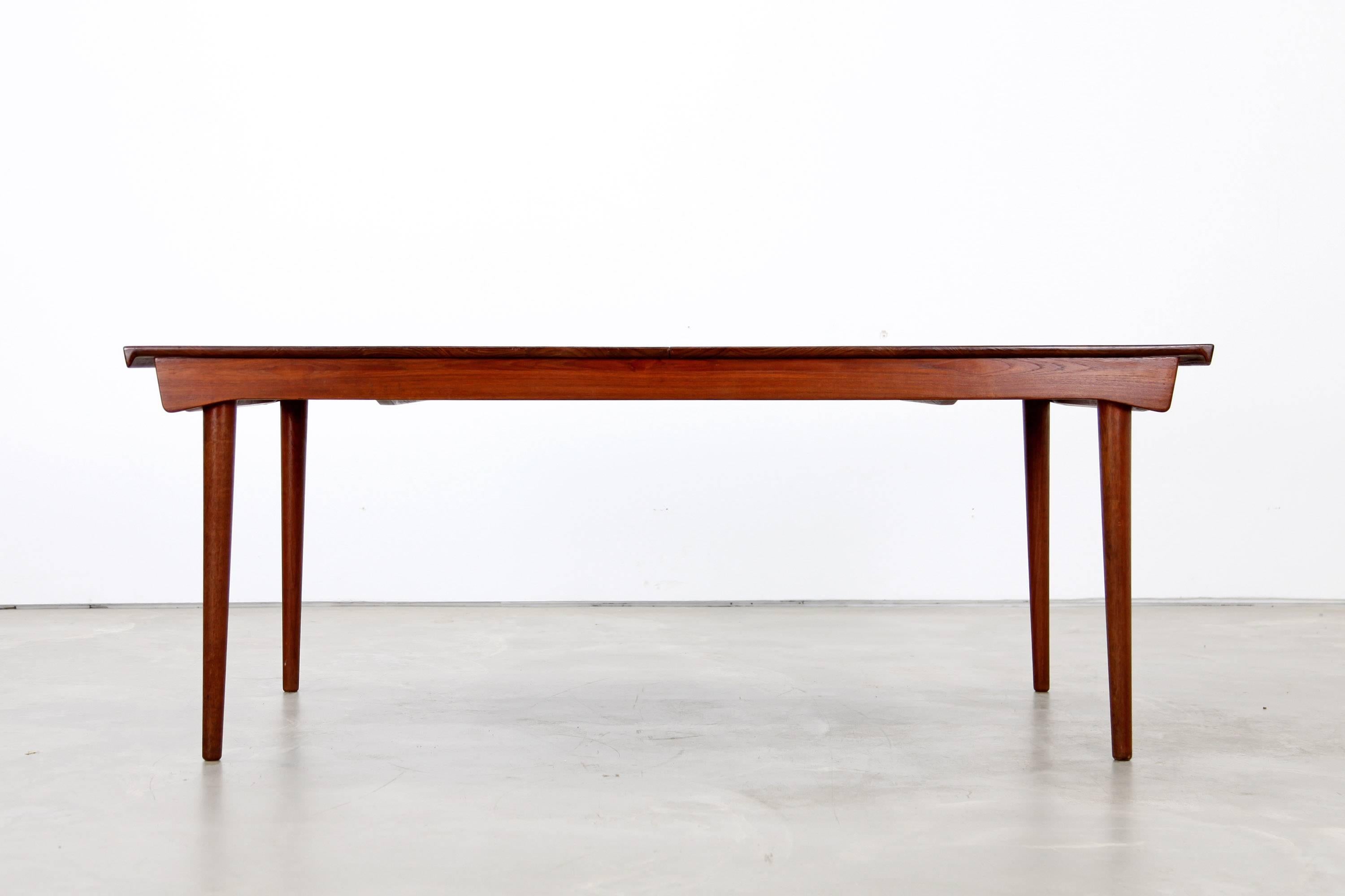 Extendable dining table, designed by Finn Juhl. This piece is made from solid wood. It is in beautiful restored condition. The table can be extended with two leaves, that are stored within the table. It can be extended in two steps from184 cm to 270