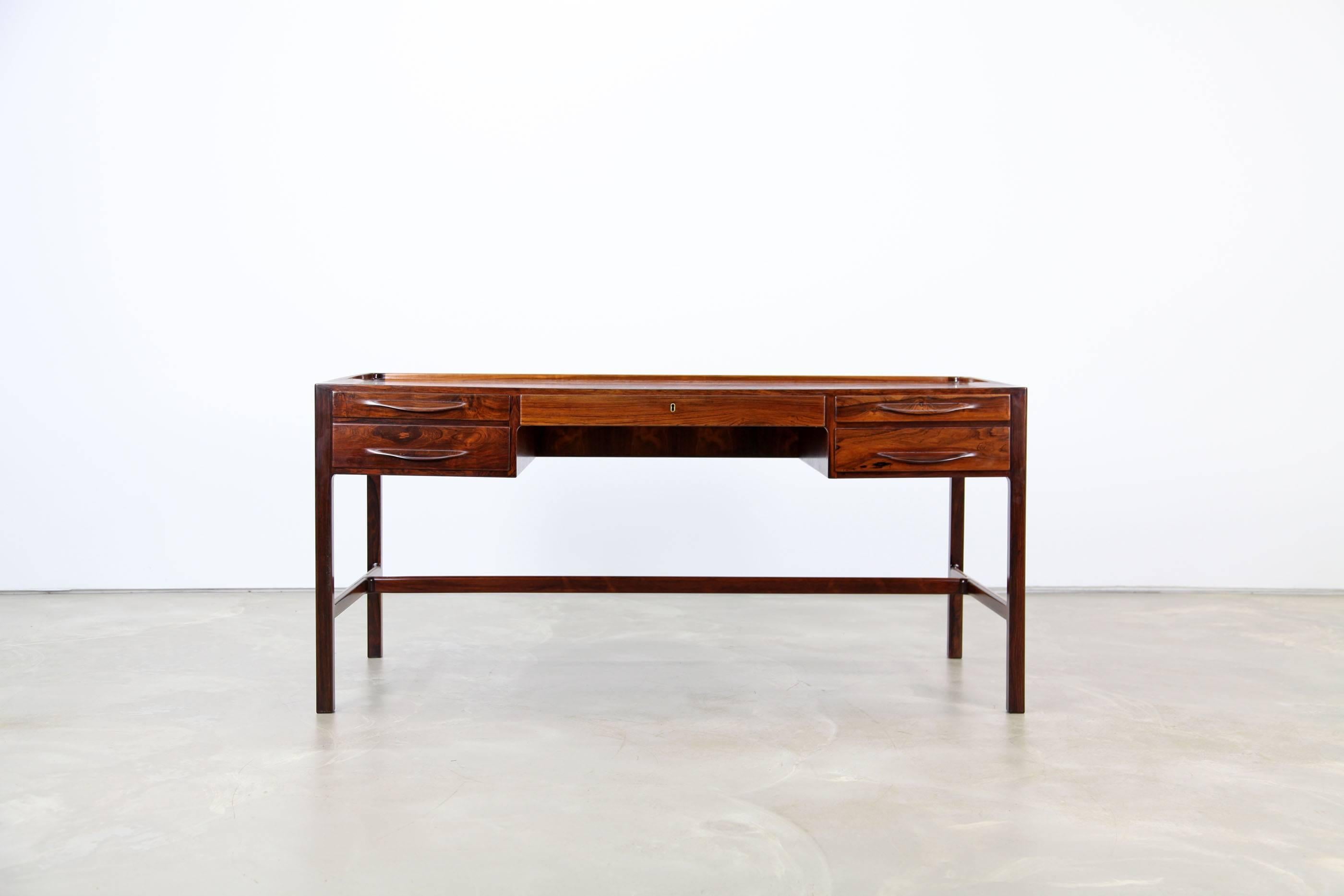 Sophisticated desk with beautifully sculpted details, designed 1957 by Kurt Østervig. This desk features finest craftsmanship and materials. It is in excellent condition.
