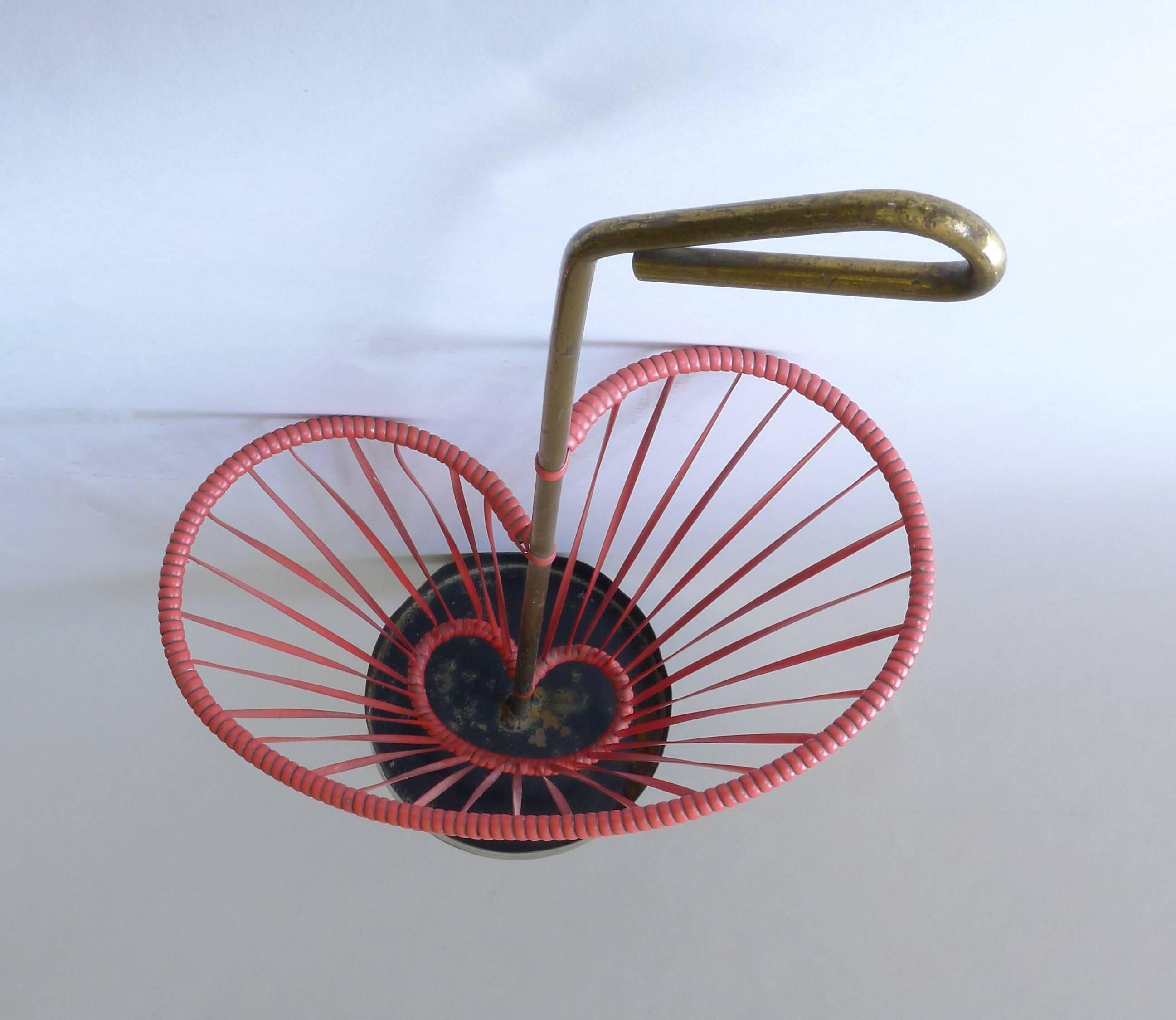 Luxus umbrella stand Aubock Era. Red rubber sting material with brass details. Purchased in Austria, but believed to be made in Sweden.

Architect, Sandy Littman of Duesenberg LTD.  and The American Glass Light Company have been making beautiful