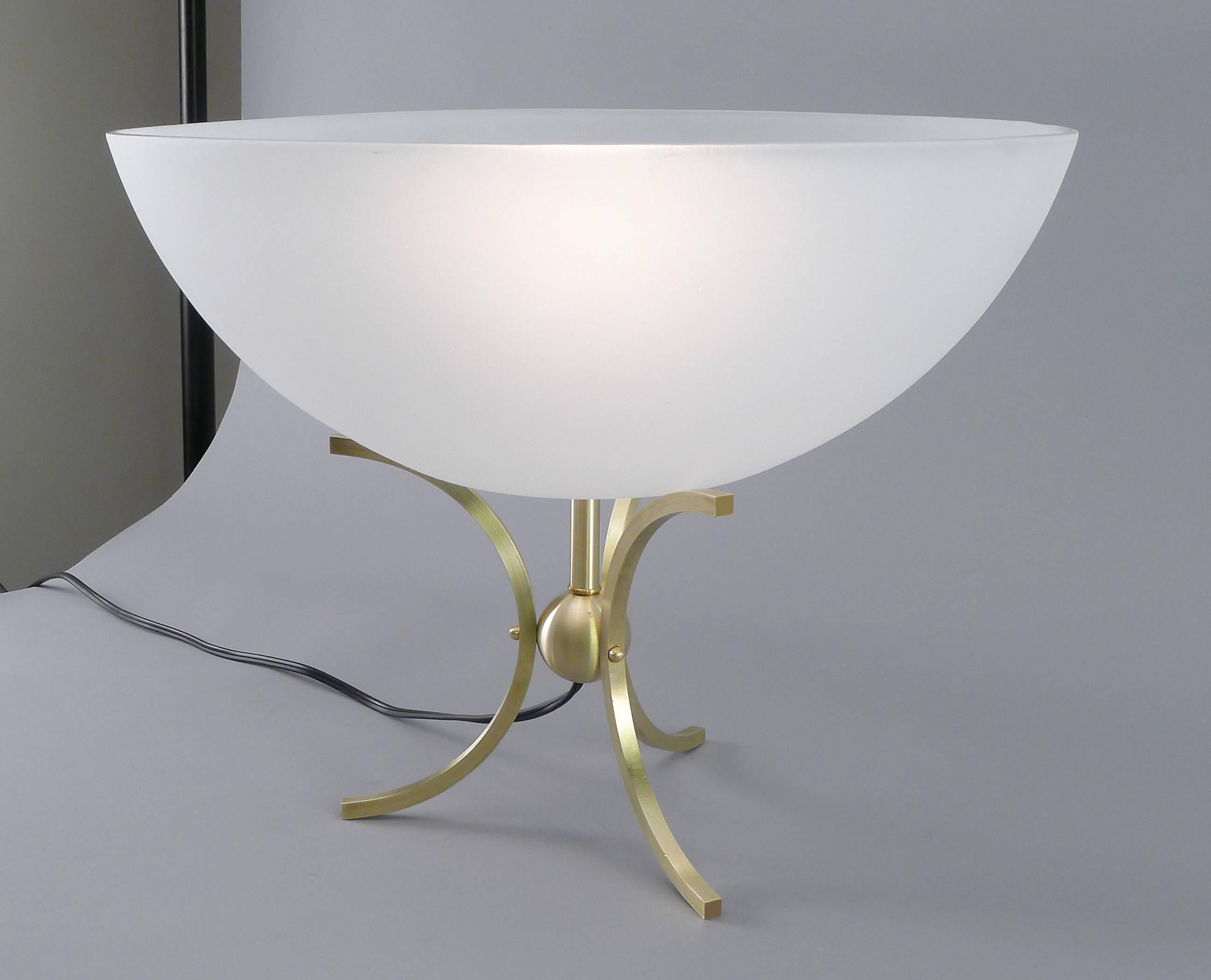 Hollywood Regency style lamp with curved brass legs. Solid brass center ball ideal for desk or pedestal. Incandescent lamping with cord, plug and switch.
Glass bowl is low-iron (no green tint) and is frosted outside.

Architect, Sandy Littman of