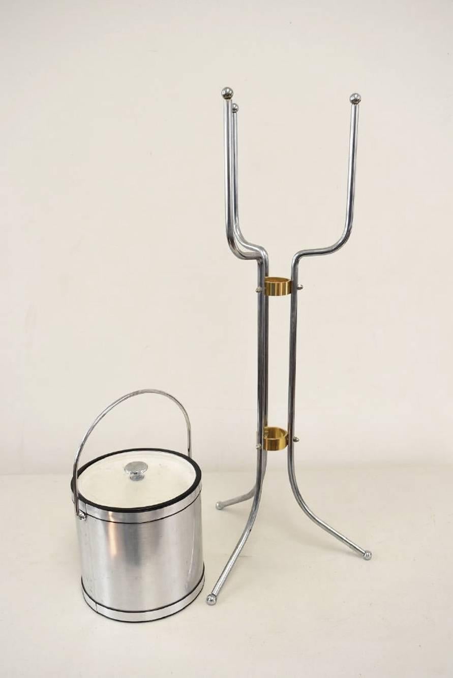 Midcentury ice bucket on stand in satin aluminum and chrome. Support rings have a brass color. Cover is clear acrylic.