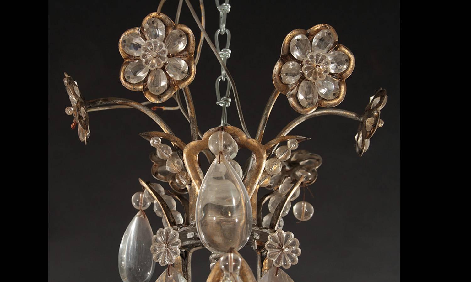 Gilt decorated wrought iron and crystal, eight-arm chandelier. Hollywood Regency period. Incandescent lamping.

Architect, Sandy Littman of Duesenberg LTD.  and The American Glass Light Company have been making beautiful objects and collecting