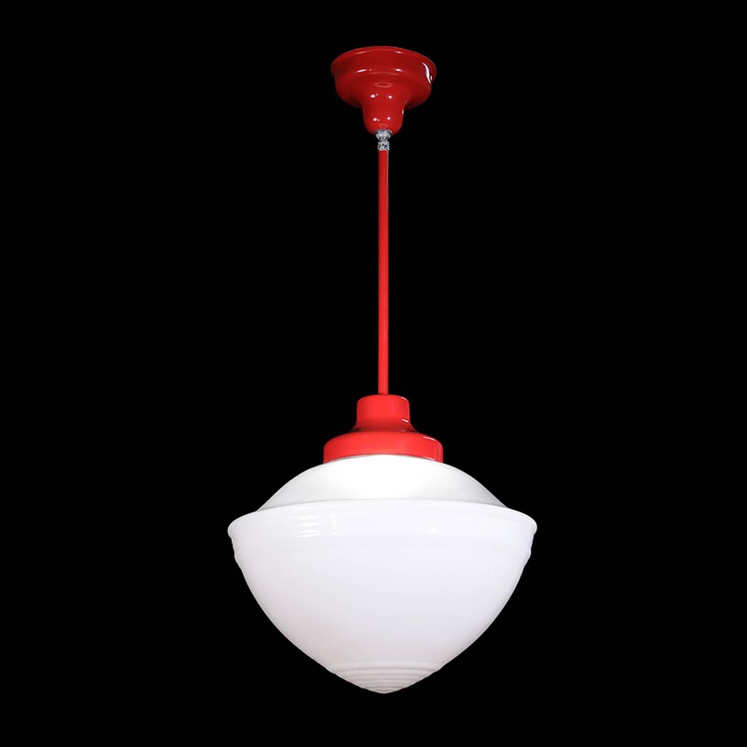 This vintage red pendant is from the 1940s and is made of painted metal. The shade has a flash white opal bottom and a clear glass top.

Architect, Sandy Littman of Duesenberg LTD.  and The American Glass Light Company have been making beautiful