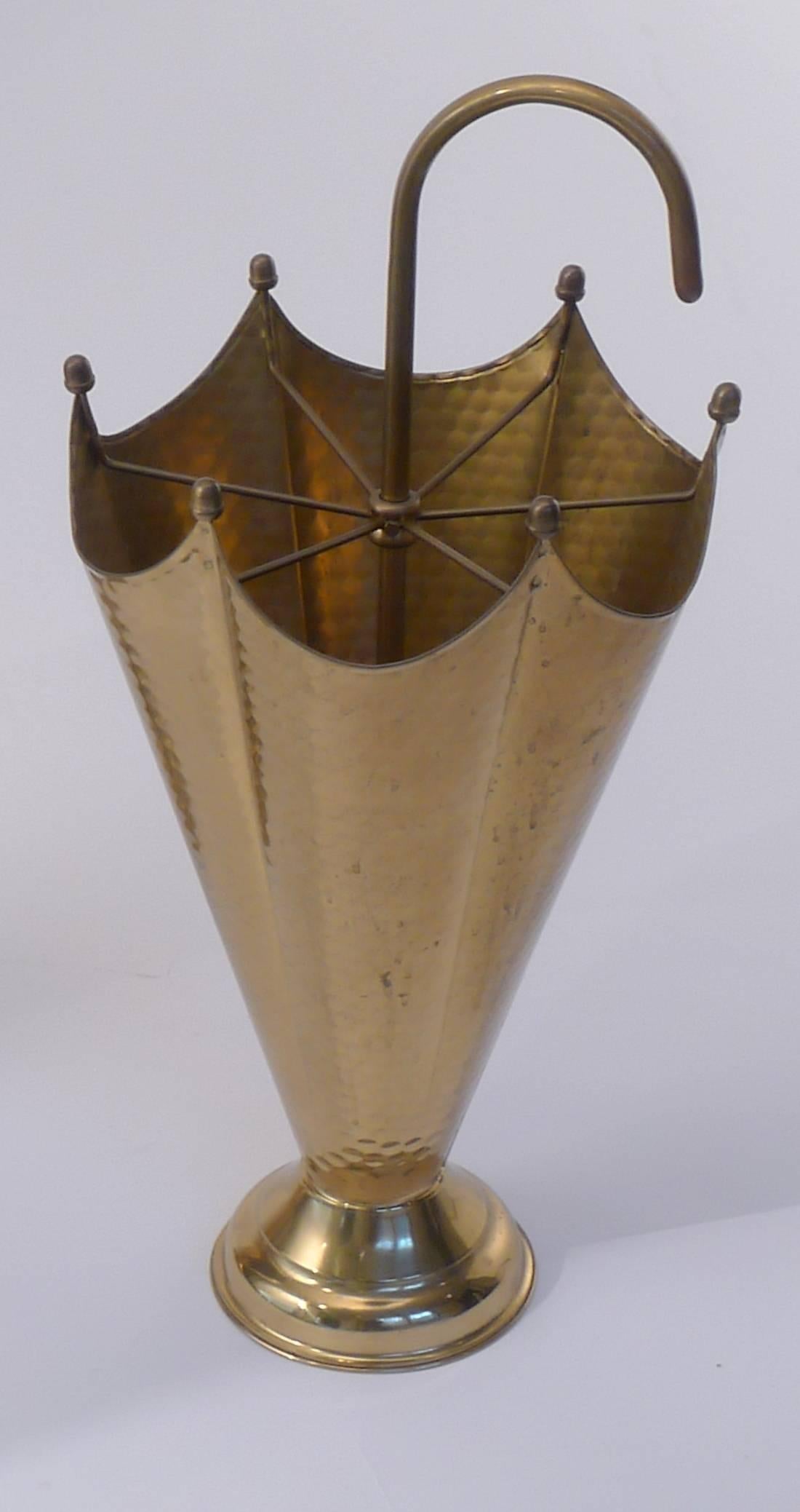Umbrella shaped hammered brass umbrella stands. 

Architect, Sandy Littman of Duesenberg LTD.  and The American Glass Light Company have been making beautiful objects and collecting gorgeous antiques for nearly 40 years.