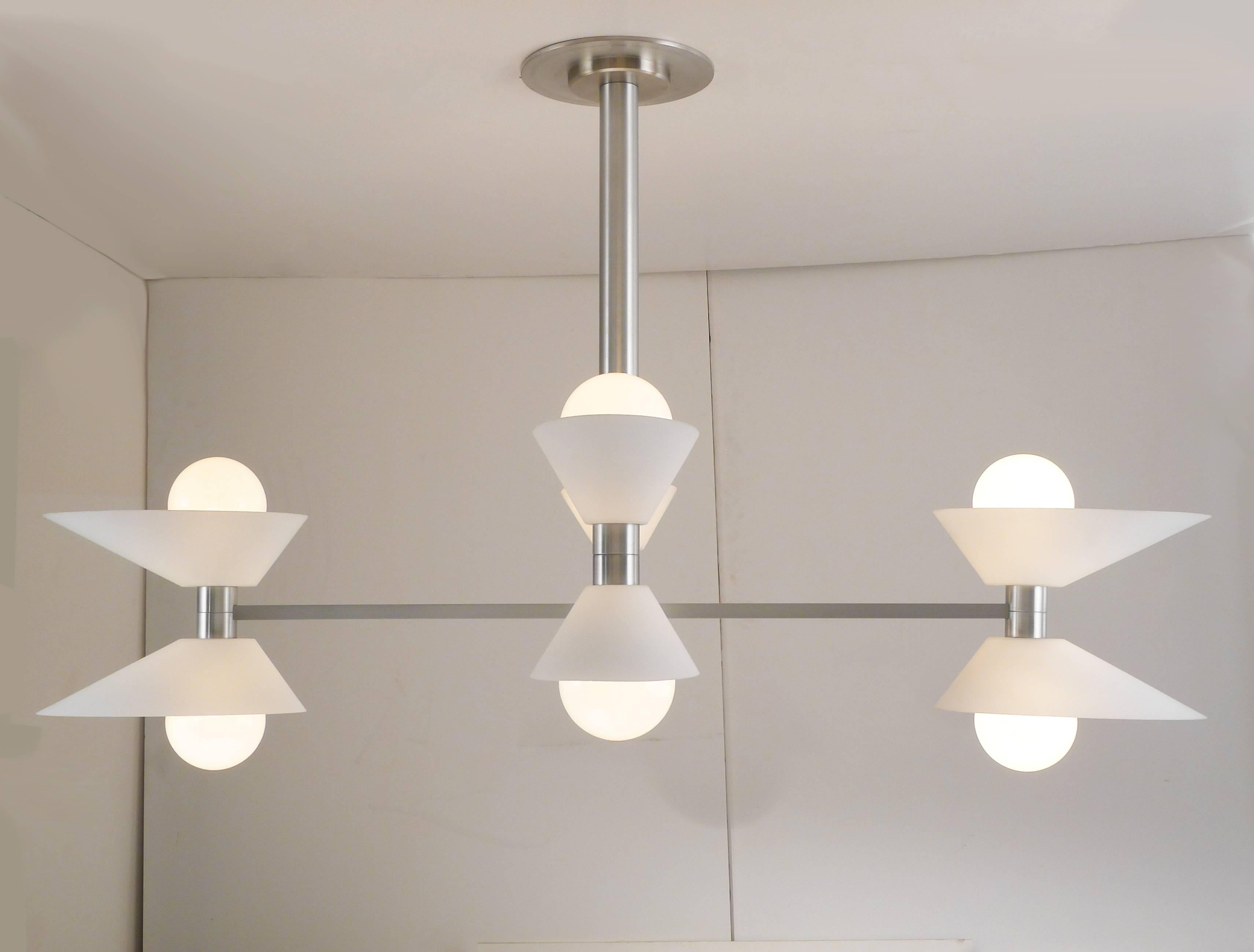 Mid-Century Modern chandelier white glass and machined aluminum.
Incandescent lamps. Designed by Architect, Sandy Littman.

Architect, Sandy Littman of Duesenberg LTD.  and The American Glass Light Company have been making beautiful objects and