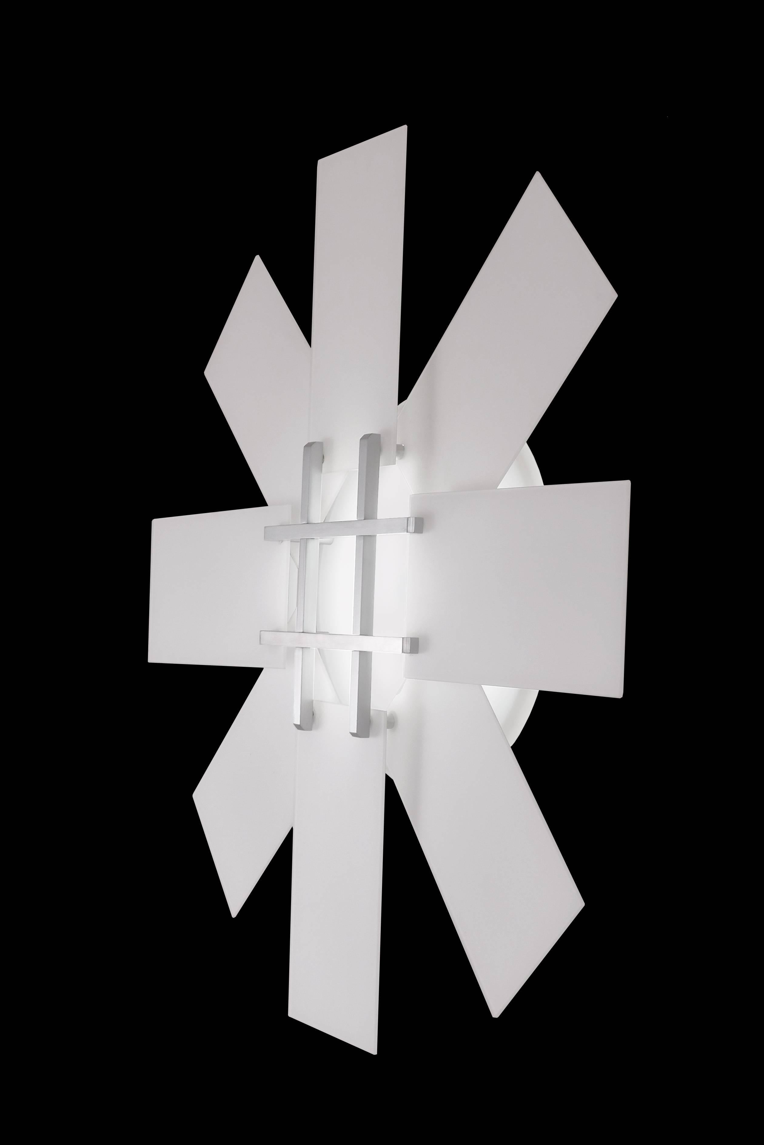 Sunflower wall sculpture consists of overlapping white glass panels, machined aluminum with LED lamping. The overlapping panels give a sense of depth with only a projection of 4 inches.
Can be used in multiples on the wall or ceiling. Can be used in