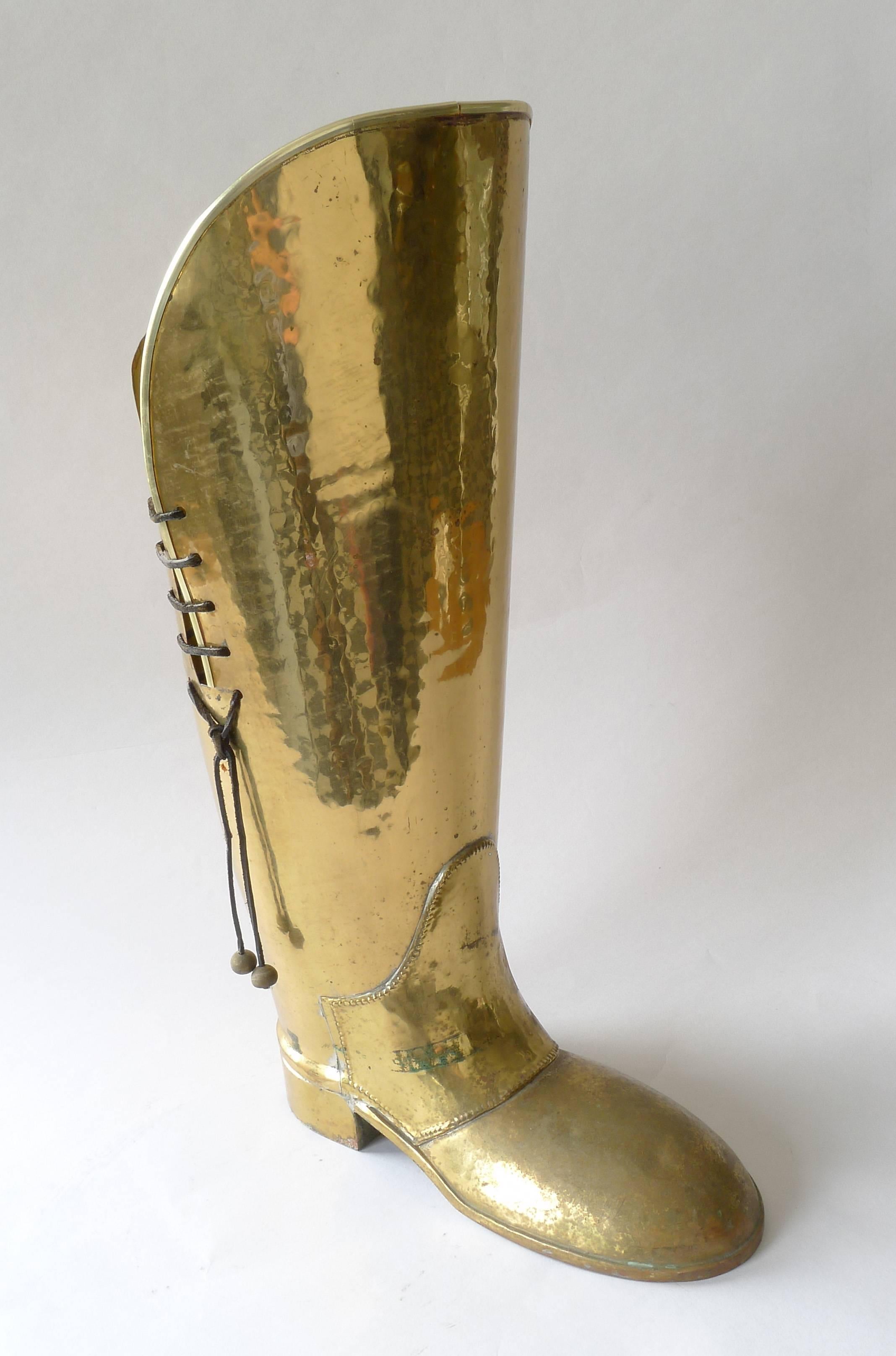 Vintage Lombard English brass boot umbrella stand. Rawhide lacing and brass tassels. Have some slight dents.

Architect, Sandy Littman of Duesenberg LTD.  and The American Glass Light Company have been making beautiful objects and collecting