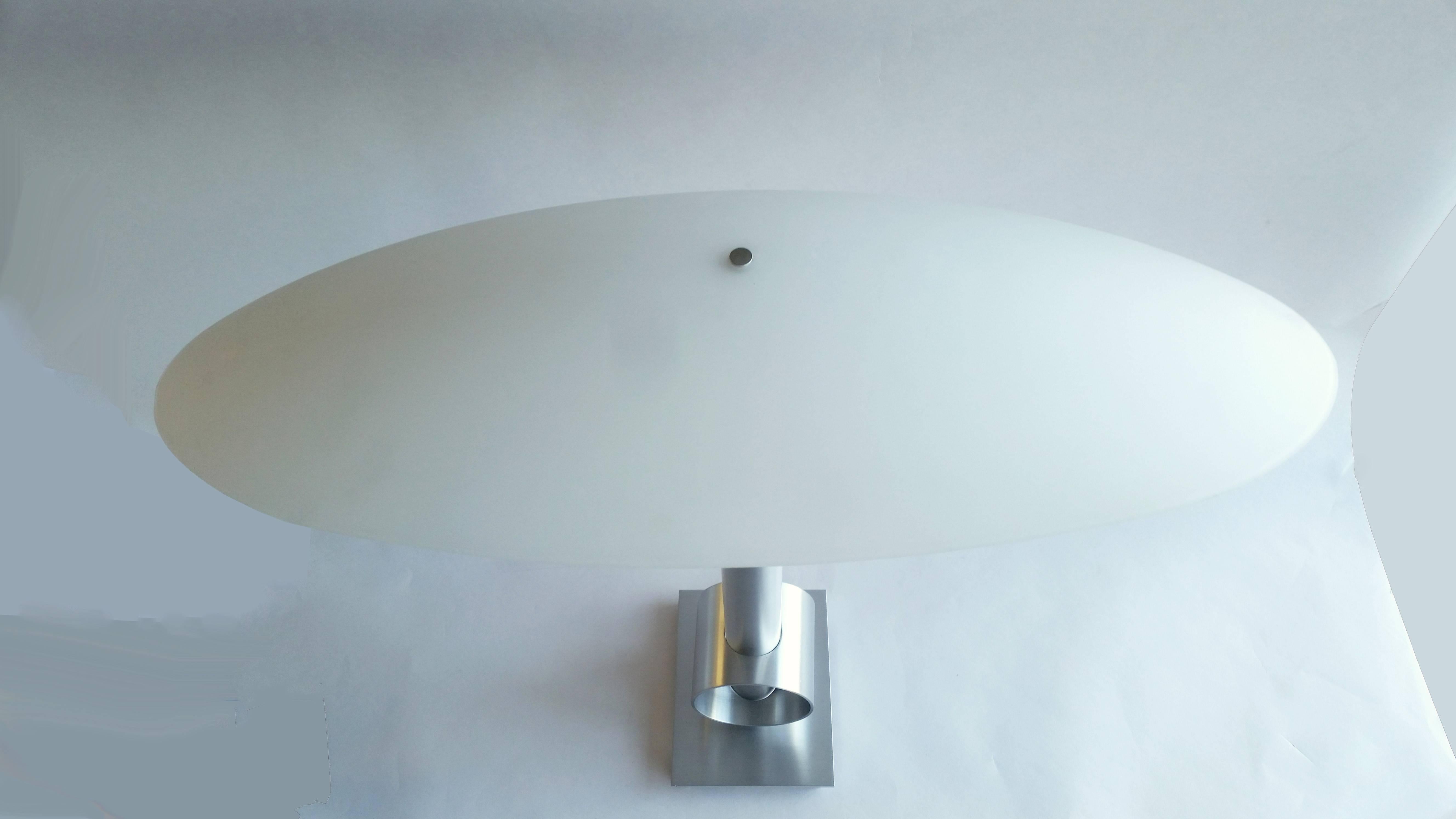 Mid-Century Modern with Bauhaus lines table lamp with large oval glass shade in satin aluminum. See additional photos for shade proportions. Incandescent lamping.

Architect, Sandy Littman of Duesenberg LTD.  and The American Glass Light Company