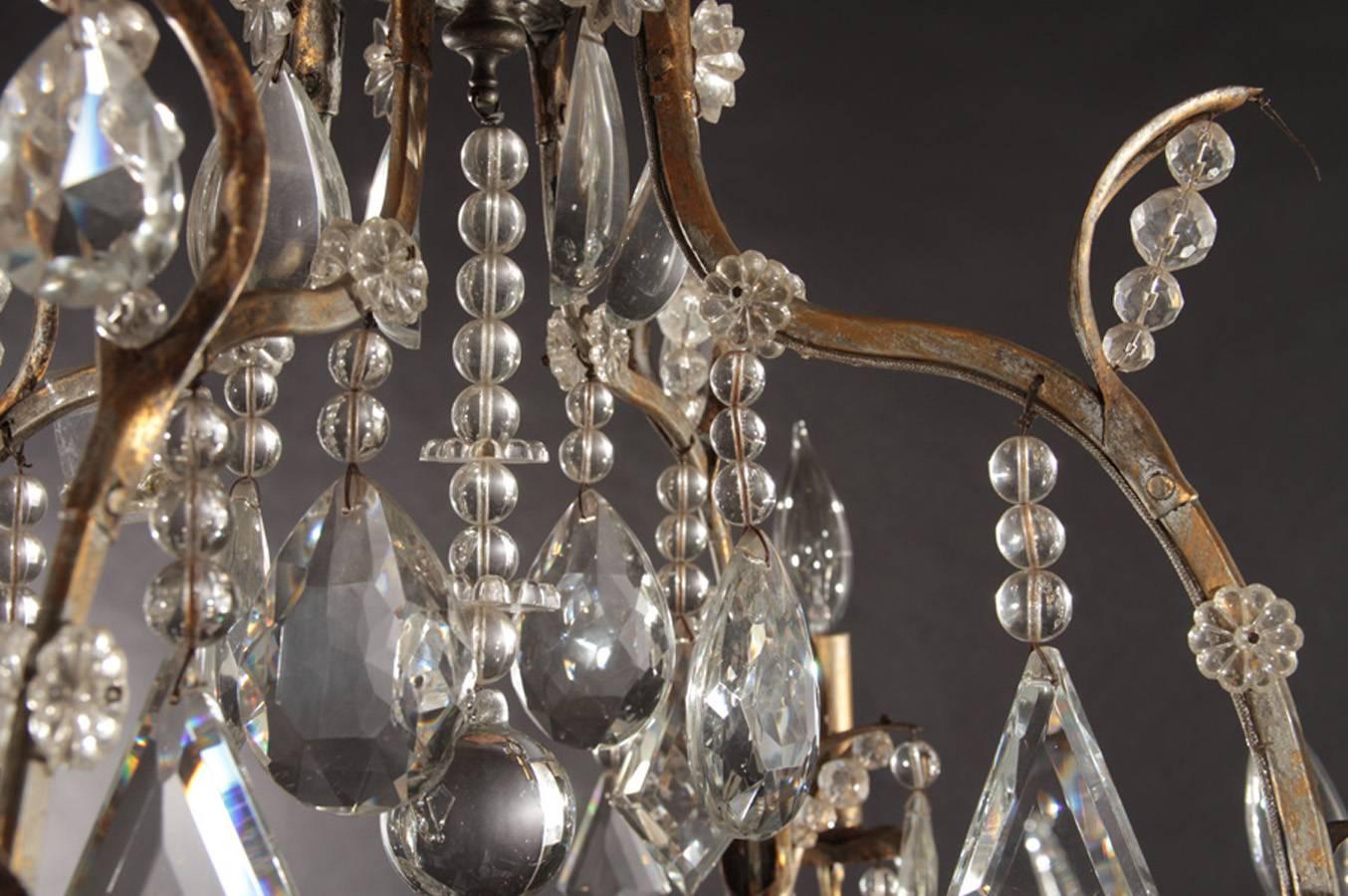 Gilt decorated wrought iron and crystal twelve-arm chandelier from the Hollywood Regency period. Incandescent lamping.

Architect, Sandy Littman of Duesenberg LTD.  and The American Glass Light Company have been making beautiful objects and