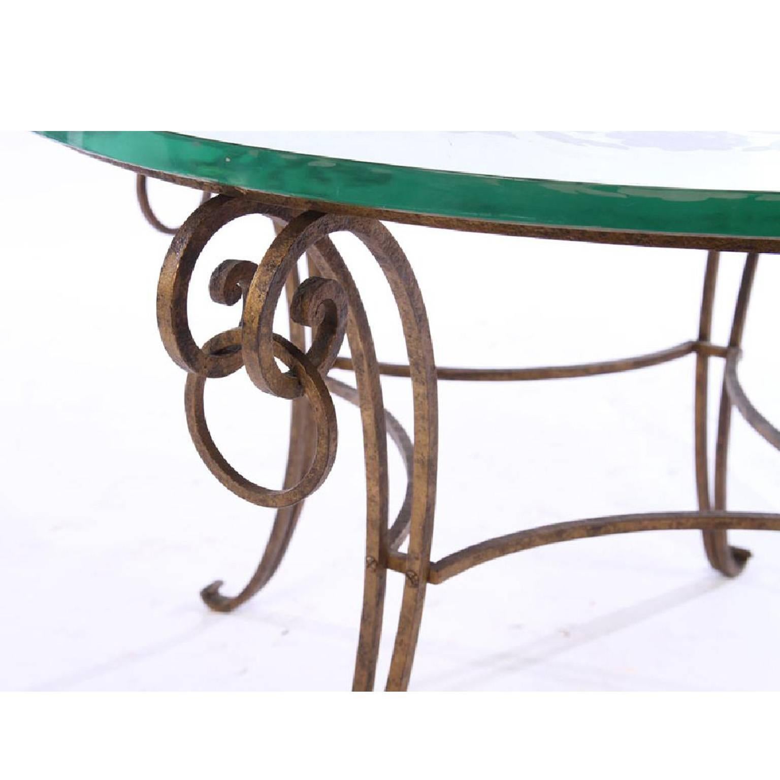 in the style of Rene Drouet mirrored French coffee table having etched floral decoration supported on wrought iron base. Mirrored top is 1 inch thick.

Architect, Sandy Littman of Duesenberg LTD.  and The American Glass Light Company have been