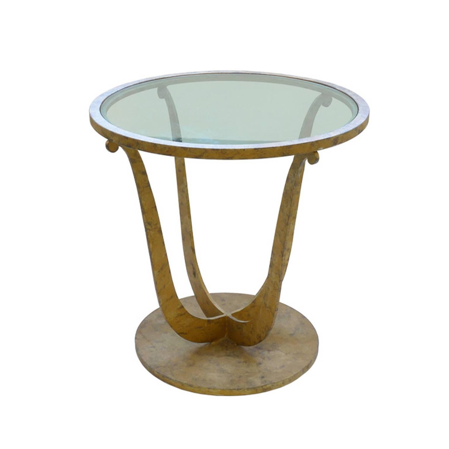Art Deco Style gilt metal round occasional table with clear glass insert. Thick round metal base four scroll shaped legs. Purchase includes 24 inch diameter flat glass pendant light, current Duesenberg LTD Production. Mid-Century Modern style. Top