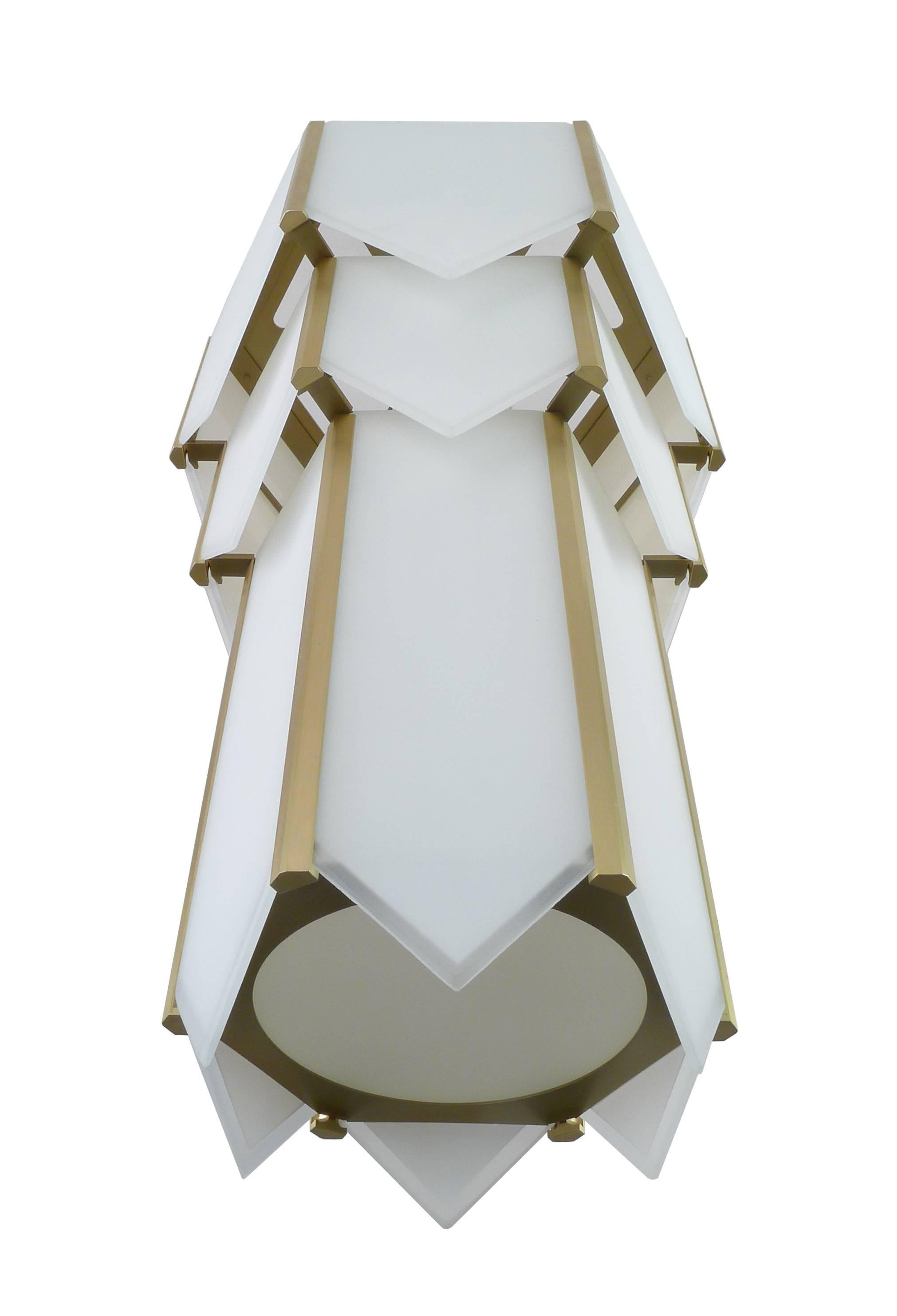 Brass metal hexagonal flush mount fixture with white glass panels. Glass panels have clear line edge detail adds depth and sparkle. Machined brass vertical bars retain glass panels. Incandescent lamping up to 100 watts.

Architect, Sandy Littman of