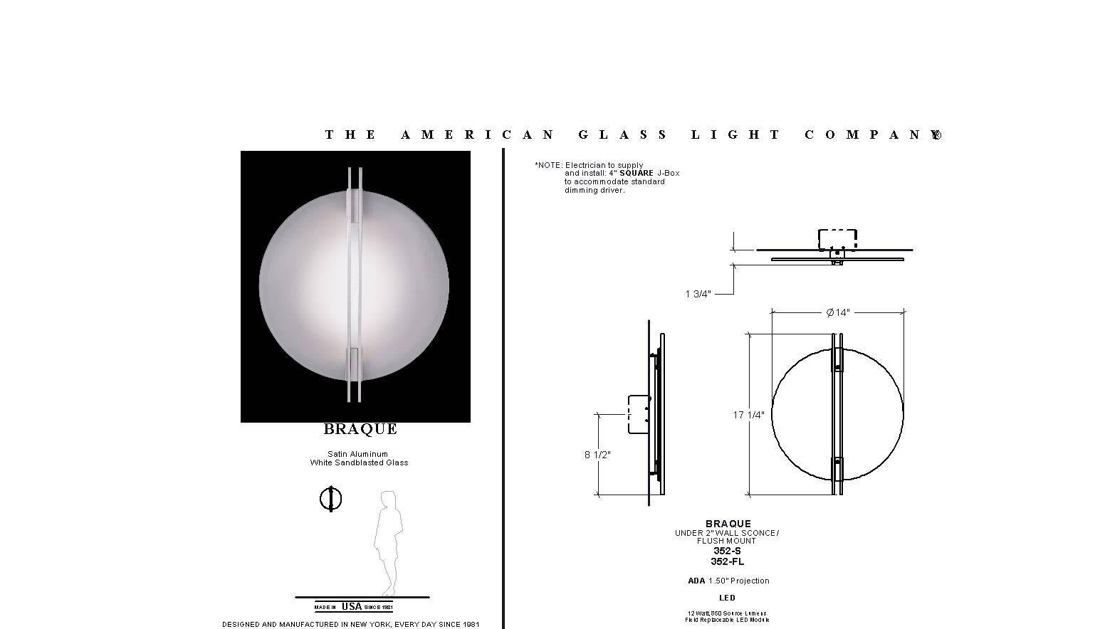 Low profile round white glass wall sconce. In the manner of streamlined moderne. Two vertical bars bisect the glass circle. LED lamping. Standard color temperature 3000k. 0-10 volt dimmable. Designed by Sandy Littman for The American Glass Light