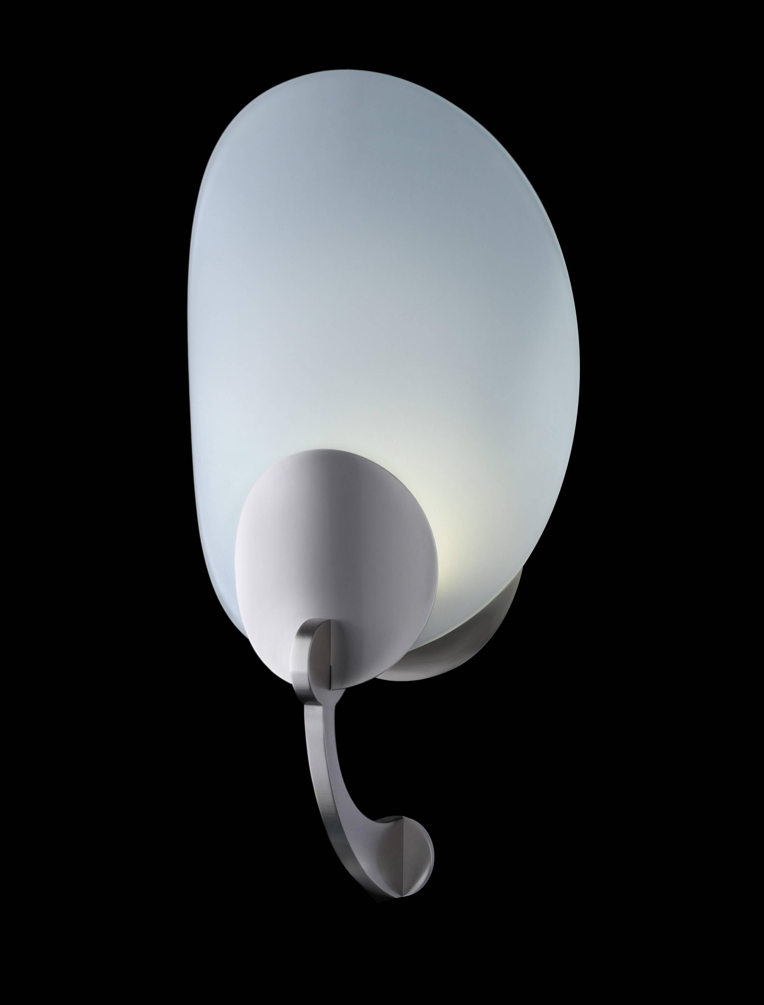 Clear frosted curved glass wall sconce. Round cast aluminium details and lower support arm. In the manner of Streamline Modern. LED lamping, 3000k standard color temperature.

Architect, Sandy Littman of Duesenberg LTD.  and The American Glass Light