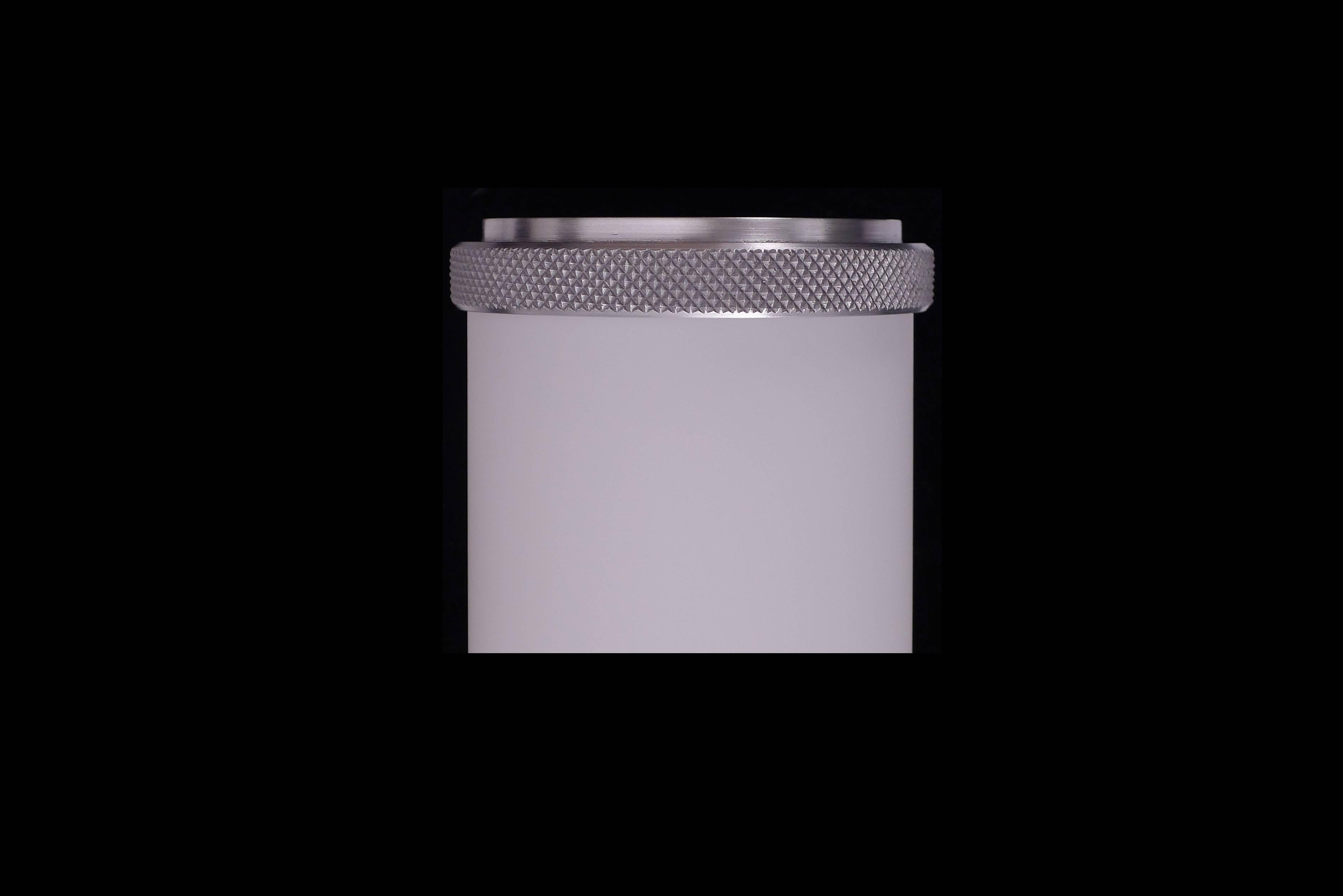 Glass sconce with knurled aluminum finials top and bottom. Rectangular aluminum backplate. In the manner of streamline moderne. LED Lamped, 3000k standard color temperature. Can also be mounted horizontally.

Architect, Sandy Littman of Duesenberg