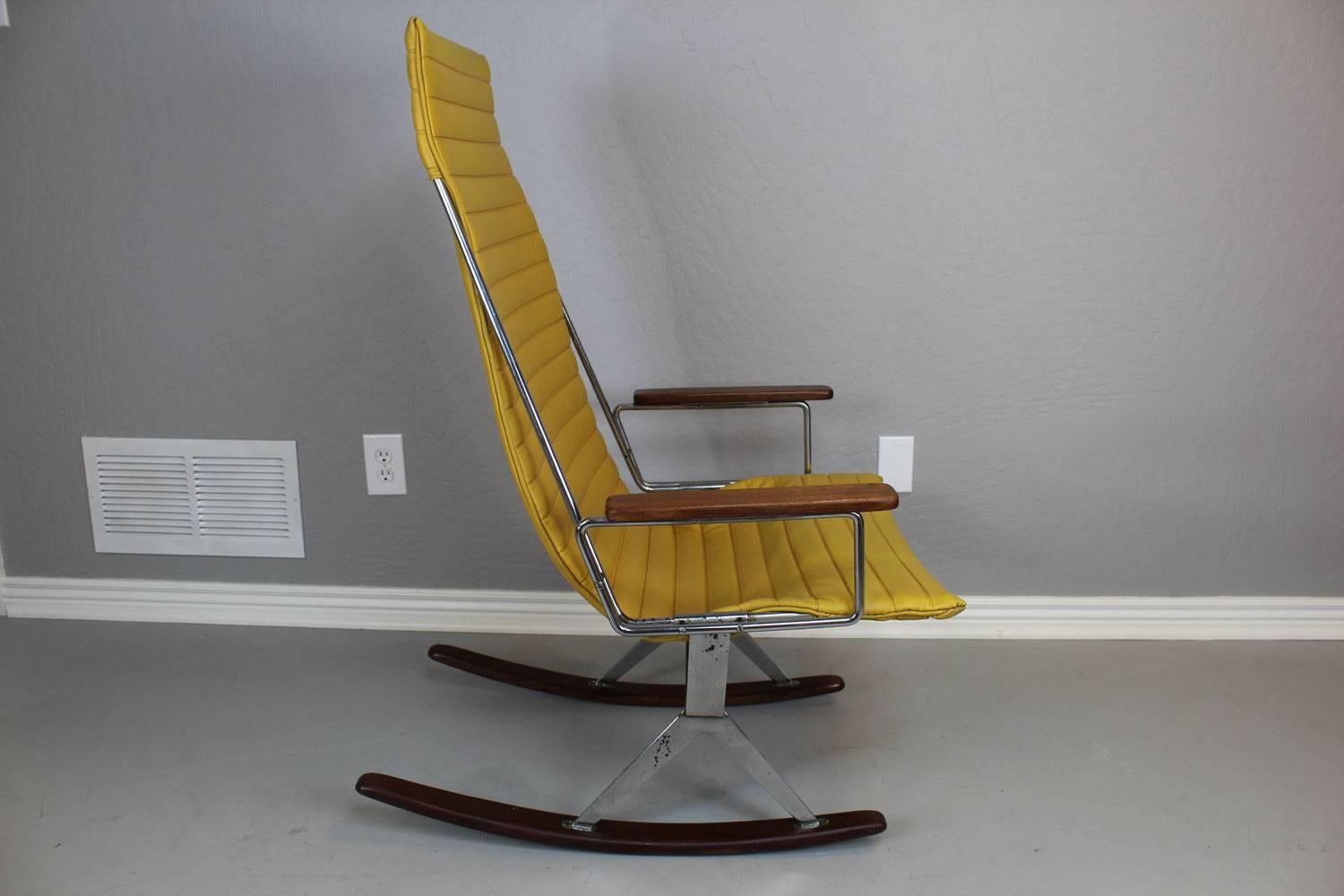 Gerald McCabe rocker for Brown Saltman. Original yellow Naugahyde sling on a chrome frame with walnut armrests and rocker runners.