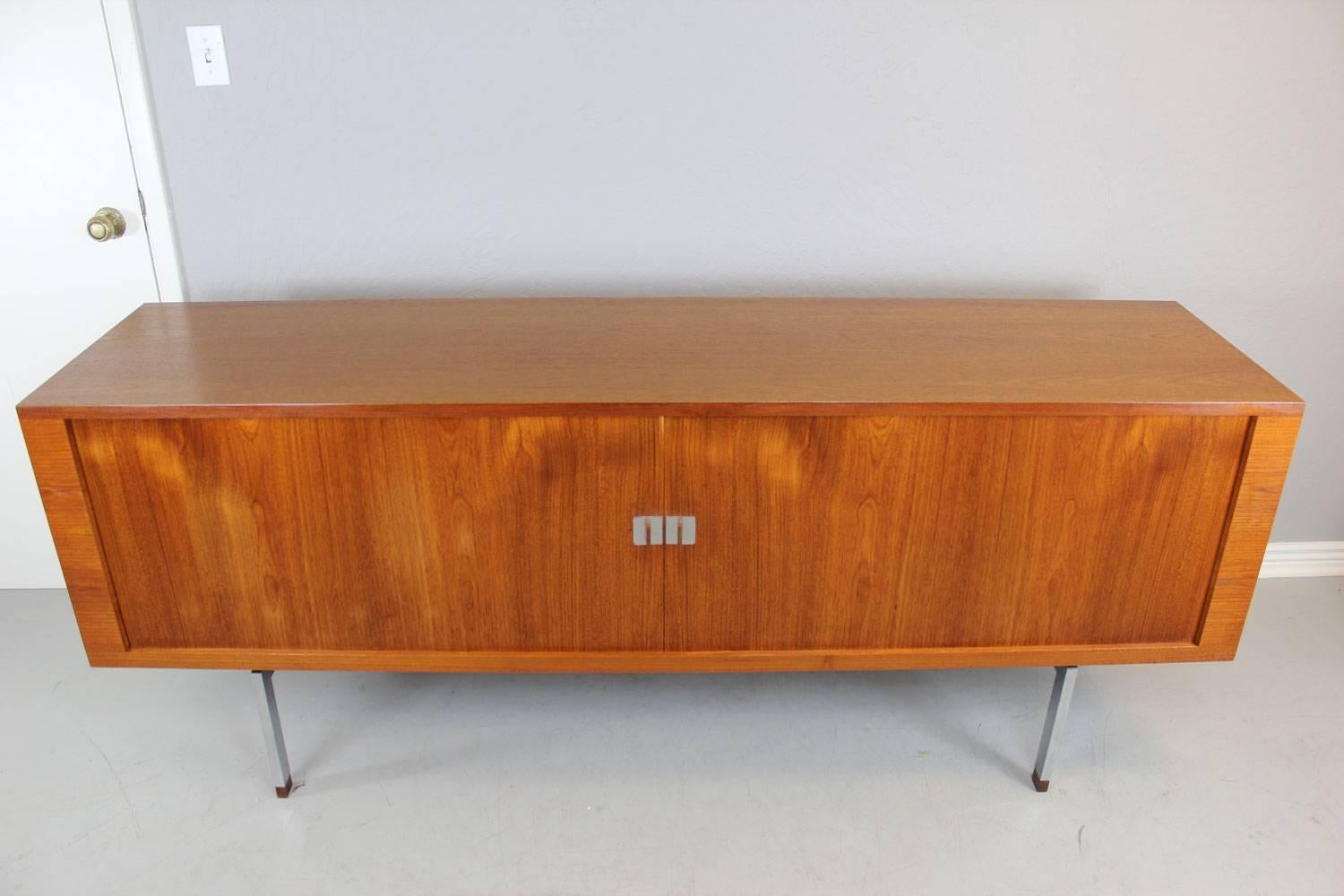 Teak and steel President credenza by Hans Wegner for Ry Mobler. Note the exceptional 3-D teak shadow casting effect on the front tambour doors.  The Tambour doors conceal 3 non-oiled original compartments (the way Ry Mobler produced these units) one