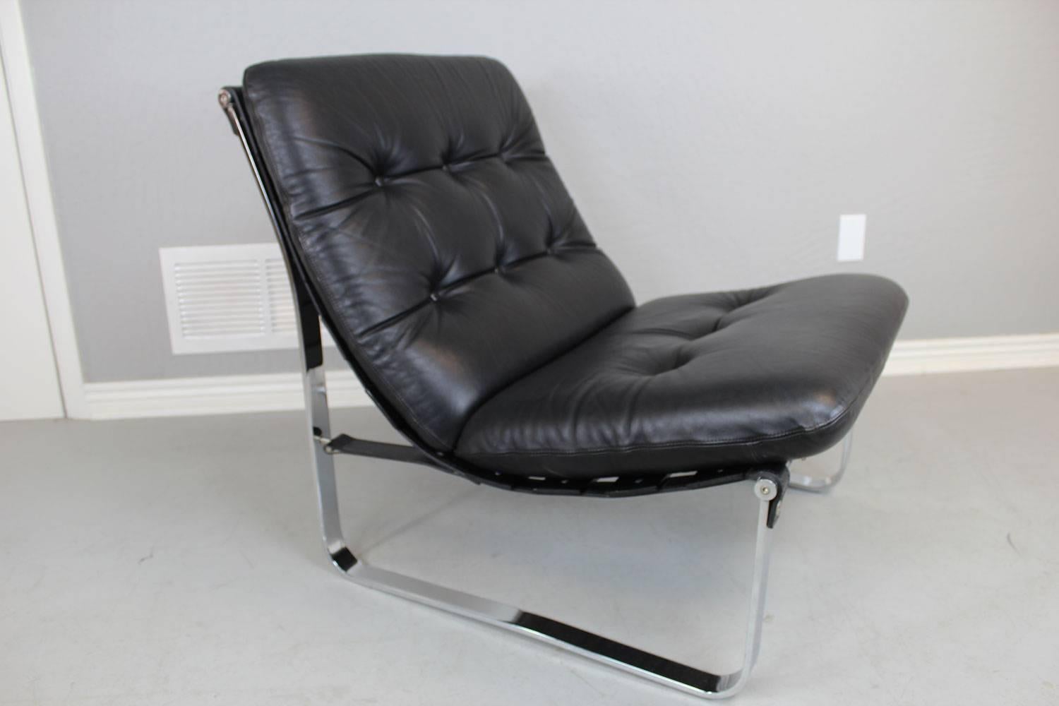 Mid-Century Modern Westnofa wood bracket back lounge chair with chrome runners and black leather attachment slings with matte black leather upholstery. 

Partial Westnofa tag on the underside of chair.