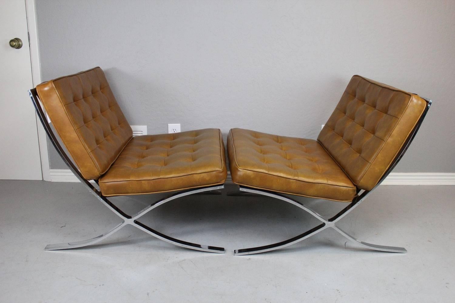 Barcelona style lounge chair pair and ottoman in caramel Naugahyde, circa 1960s. All straps in exceptional condition and no rips, tears, or holes in Naugahyde. A very nice reproduction set. The stainless steel construction of these units is heavy
