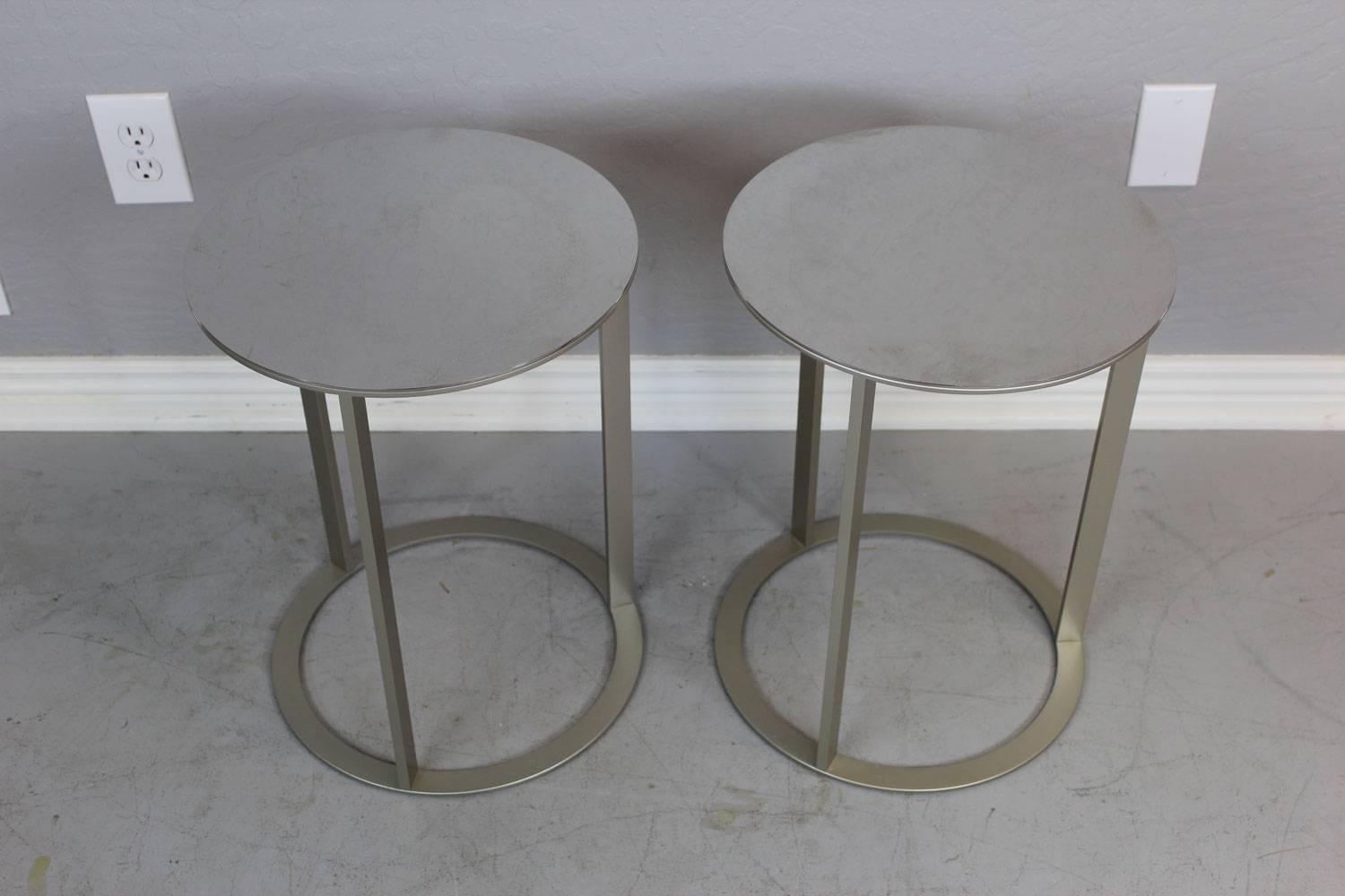 Sleek modern stainless steel table pair by Antonio Citterio.