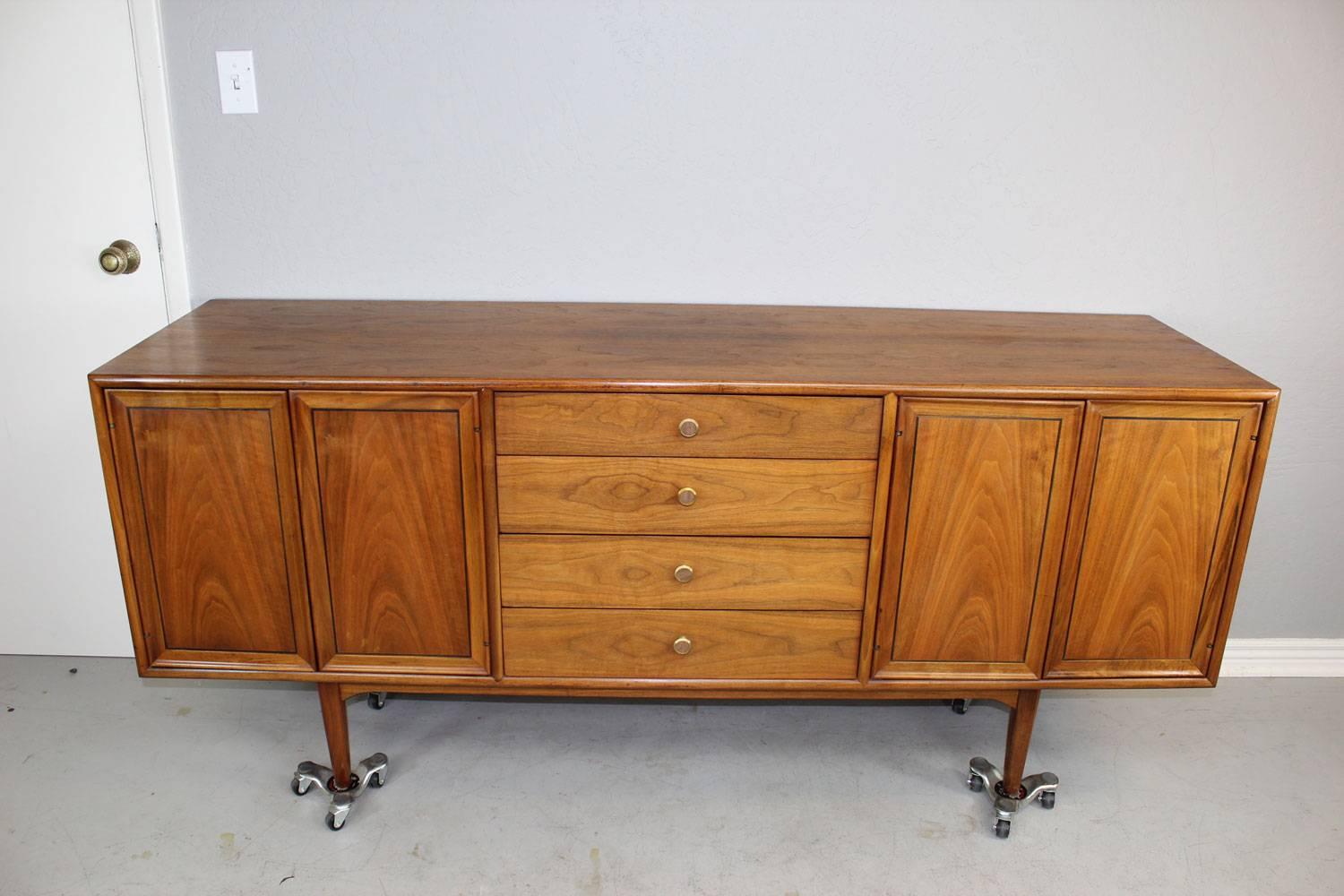 Unique Mid-Century Modern four-drawer credenza by Drexel in walnut with lighted interior cabinets. Professionally restured.