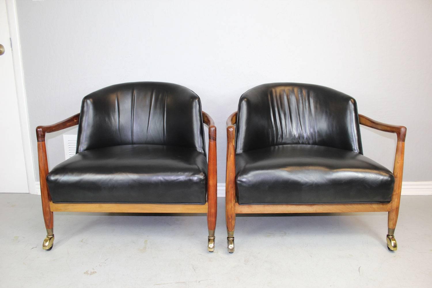 T.H. Robsjohn-Gibbings club chairs in black leather for Widdicomb. Professionally restored.