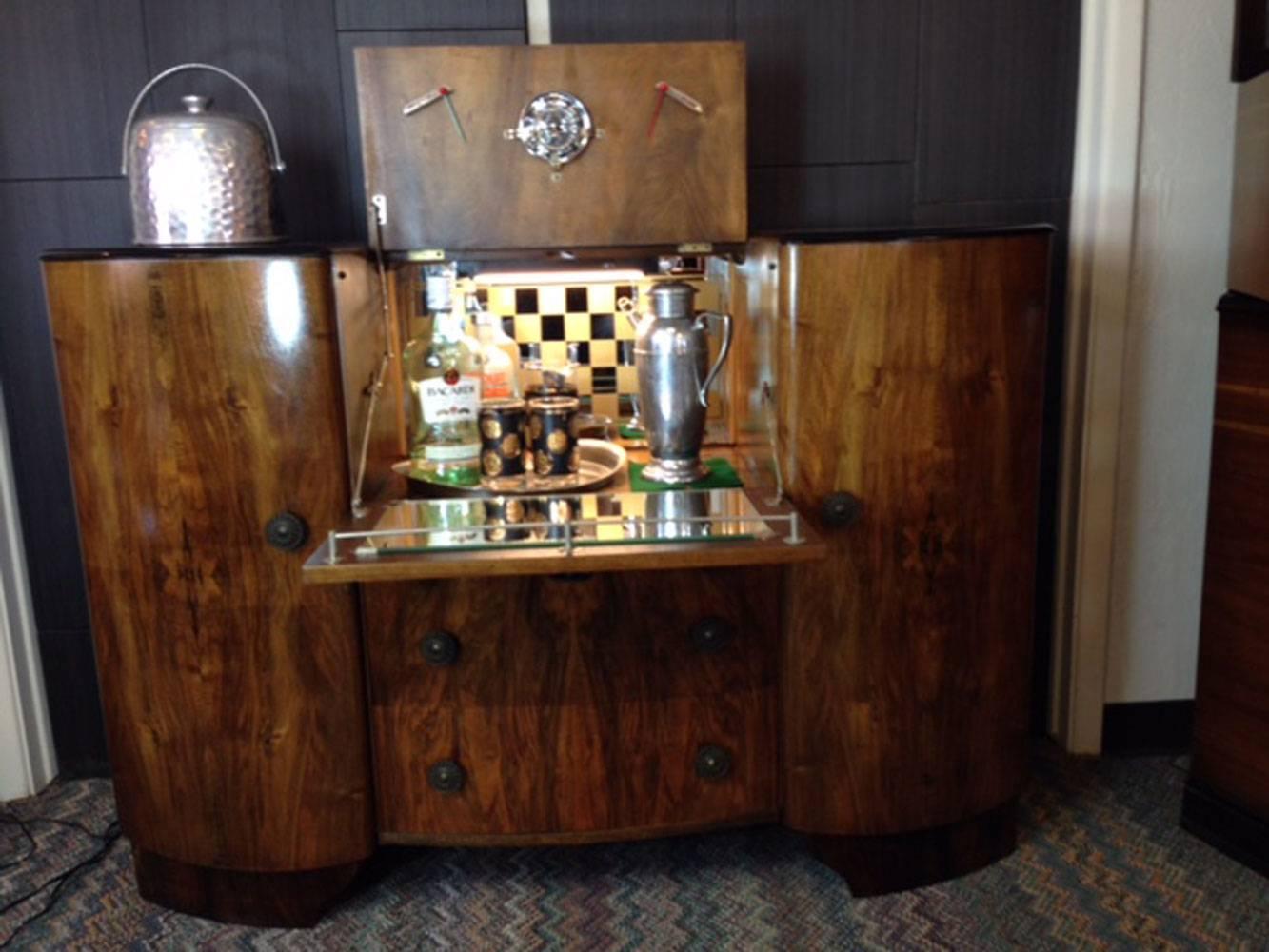 Fully restored Art Deco bar! Also a must for the mid-century modern enthusiast! Two cabinet’s doors each contain a shelf to store all your favorite spirits. Two pull-out drawers for your extra glassware and other bar accessories. The top folds down